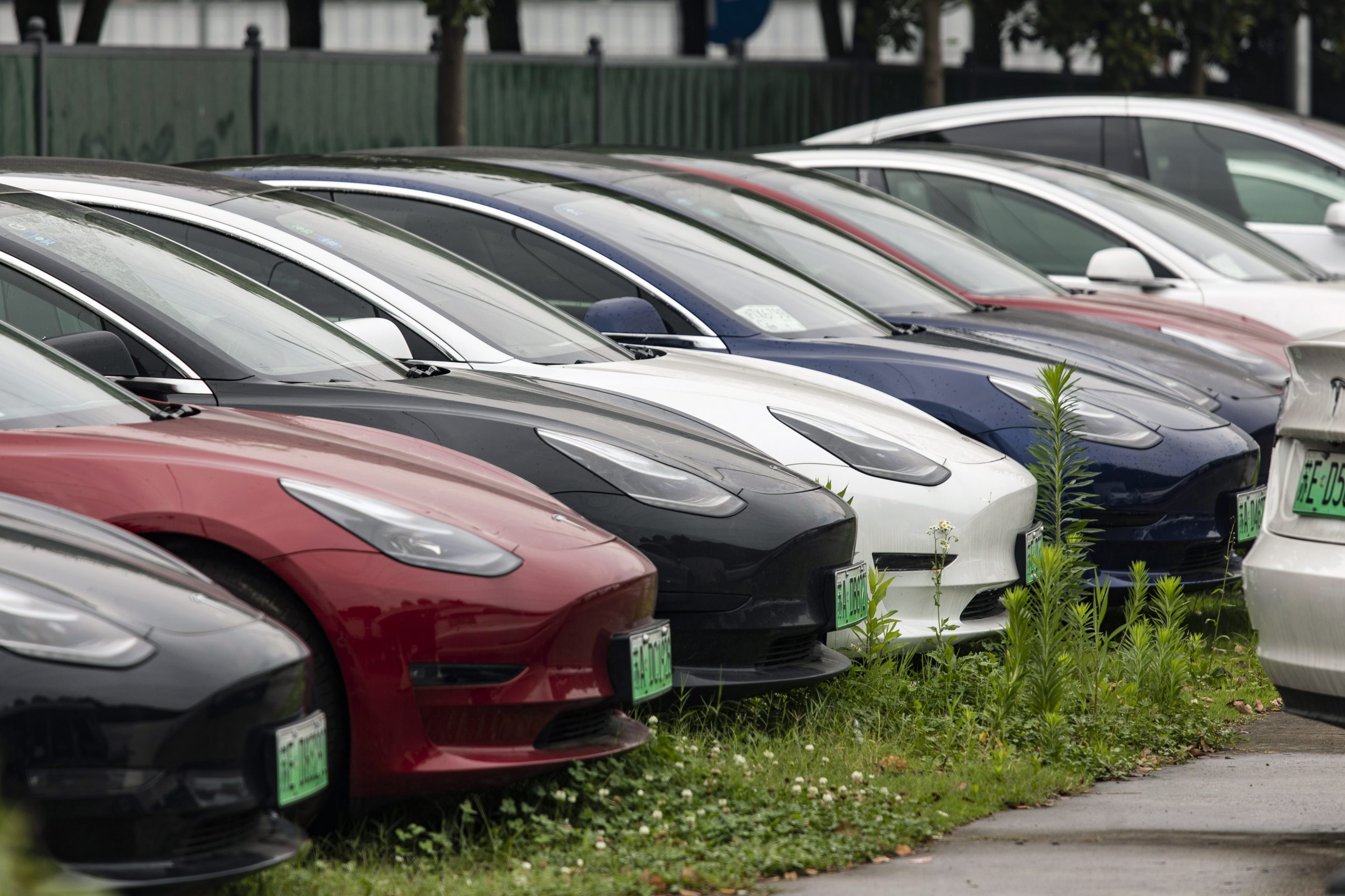Tesla Inc. Model 3 electric vehicles in a parking lot near one of the automaker's dealership in Shanghai, China, on Saturday, July 3, 2021.