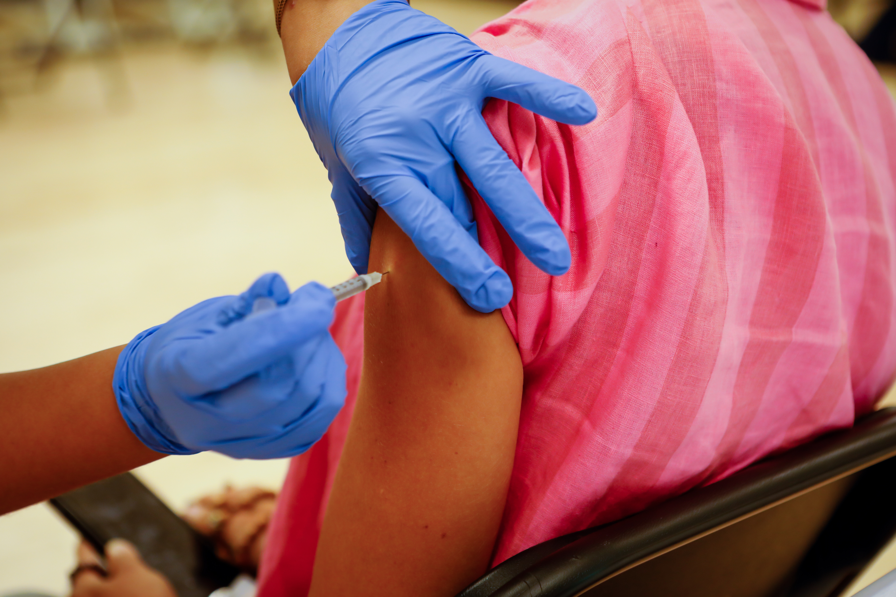 A healthcare worker administers a dose of the Pfizer-BioNTech Covid-19 vaccine at the Key Biscayne Community Center in Key Biscayne, Florida, U.S., on Tuesday, Aug. 24, 2021.
