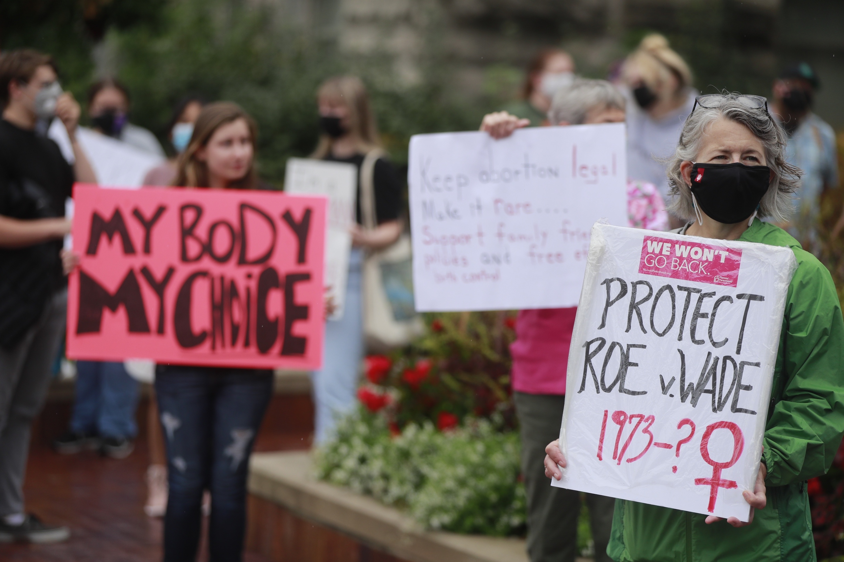 A woman holds a placard referring to Roe vs Wade as demonstrators gather at the Sample Gates at Indiana University to rally in support of women’s reproductive rights, in Bloomington.