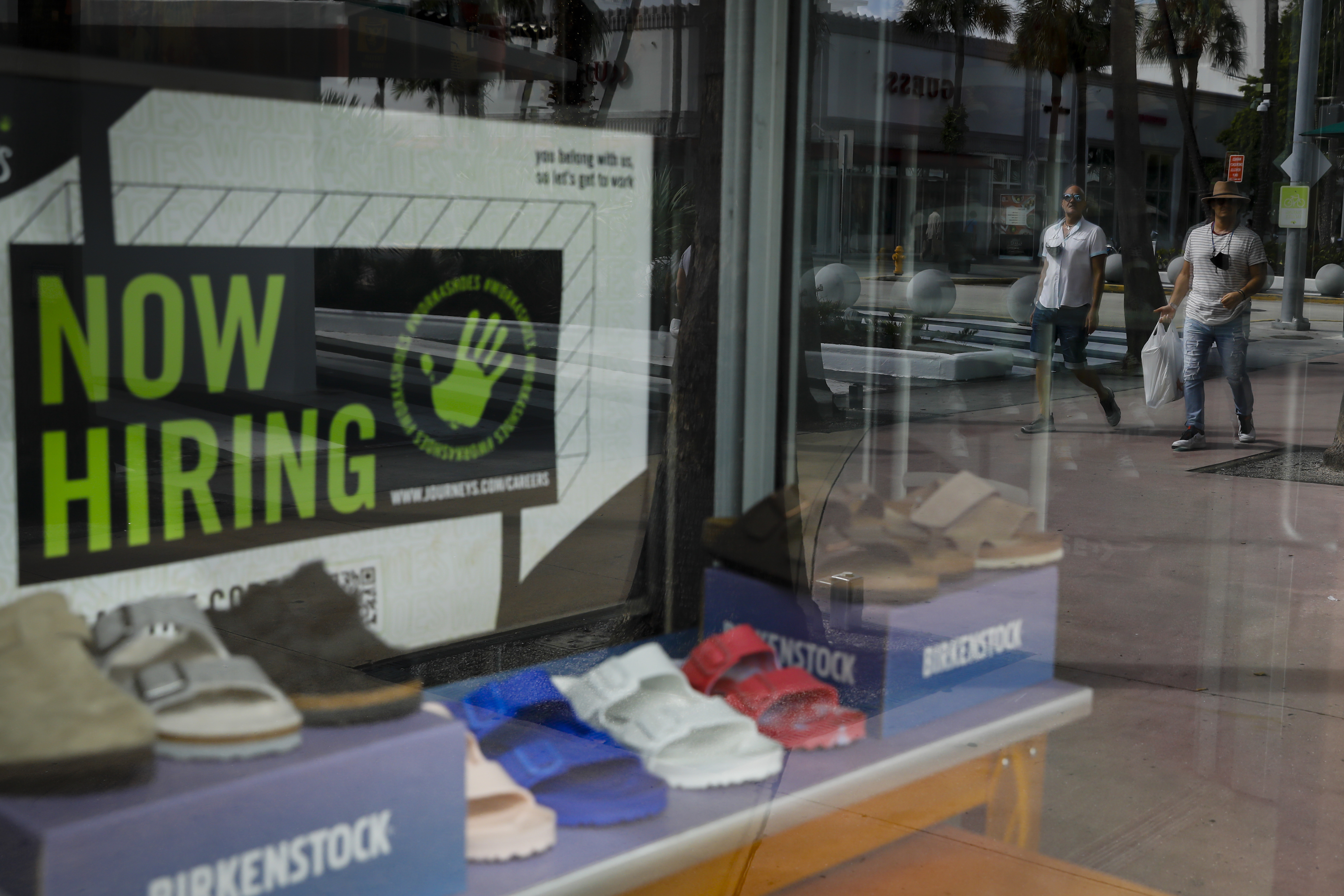 A "Now Hiring" sign outside a shoe store in Miami on Oct. 23, 2021.