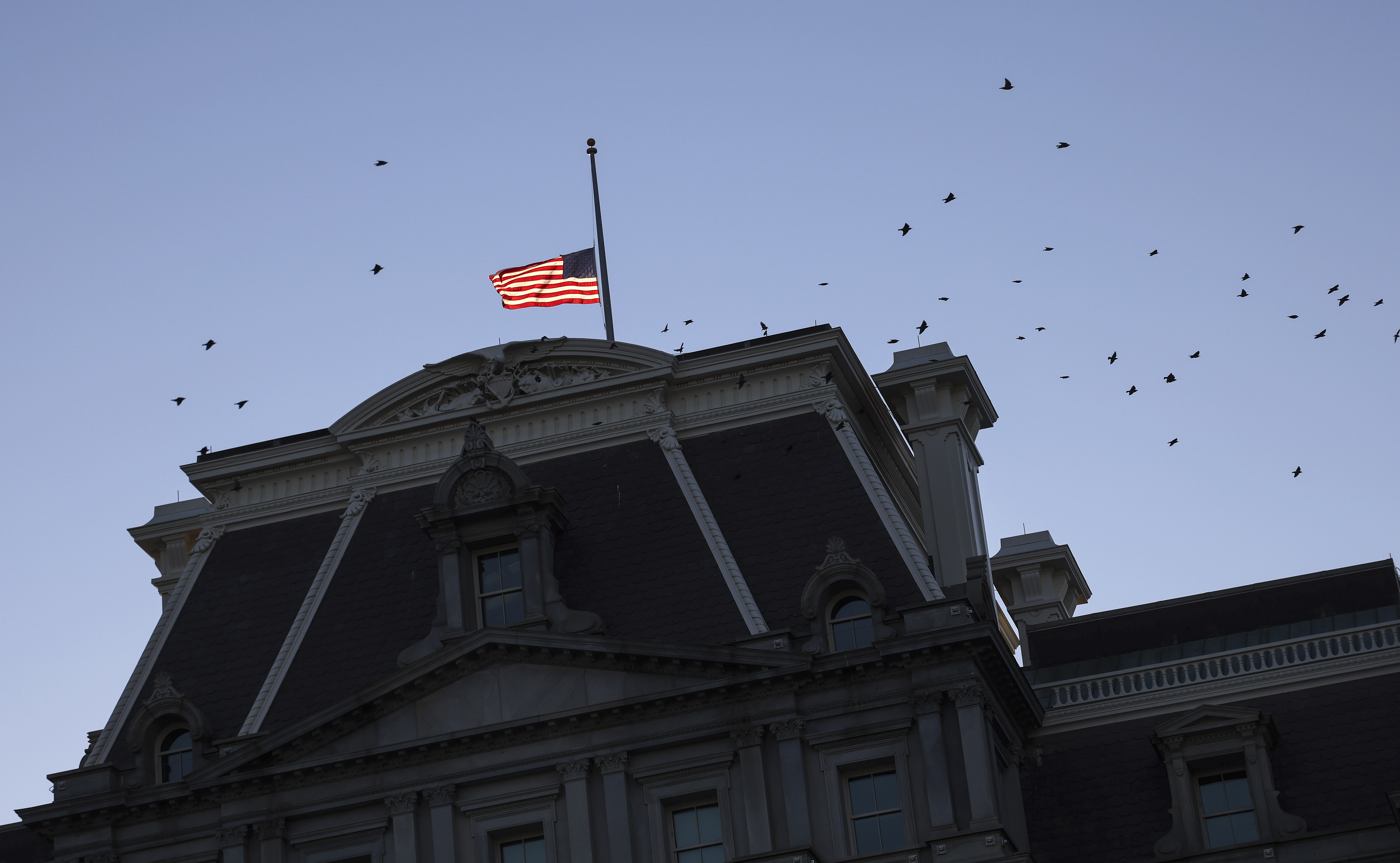 The American flag on top of the Eisenhower Executive Office Building, near the White House, flies at half staff, following the death of former Secretary of State Colin Powell, on October 18, 2021 in Washington, DC. Powell, 84, died Monday due to complications from Covid-19. 