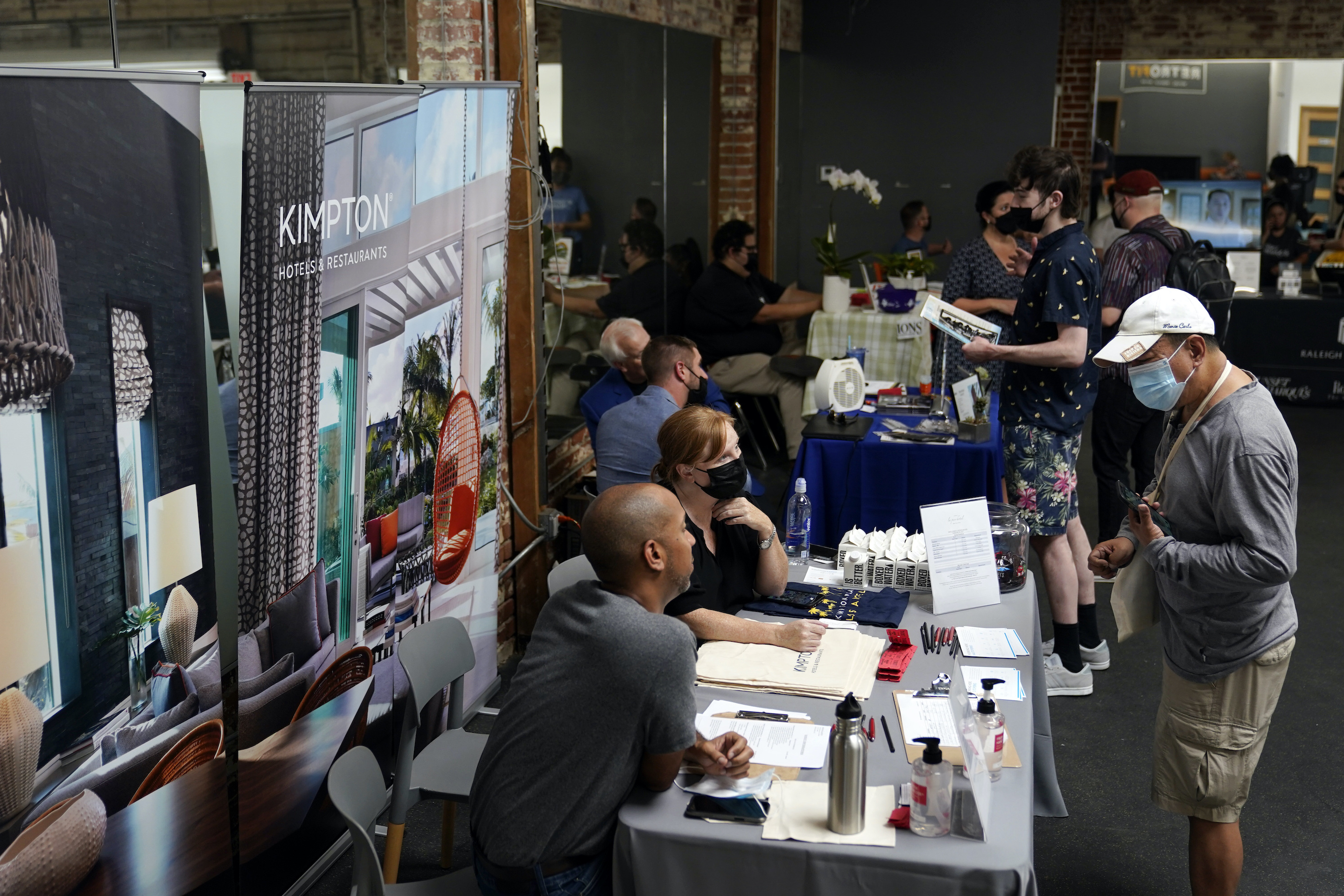 Prospective employers and job seekers interact during a job fair in the West Hollywood section of Los Angeles.