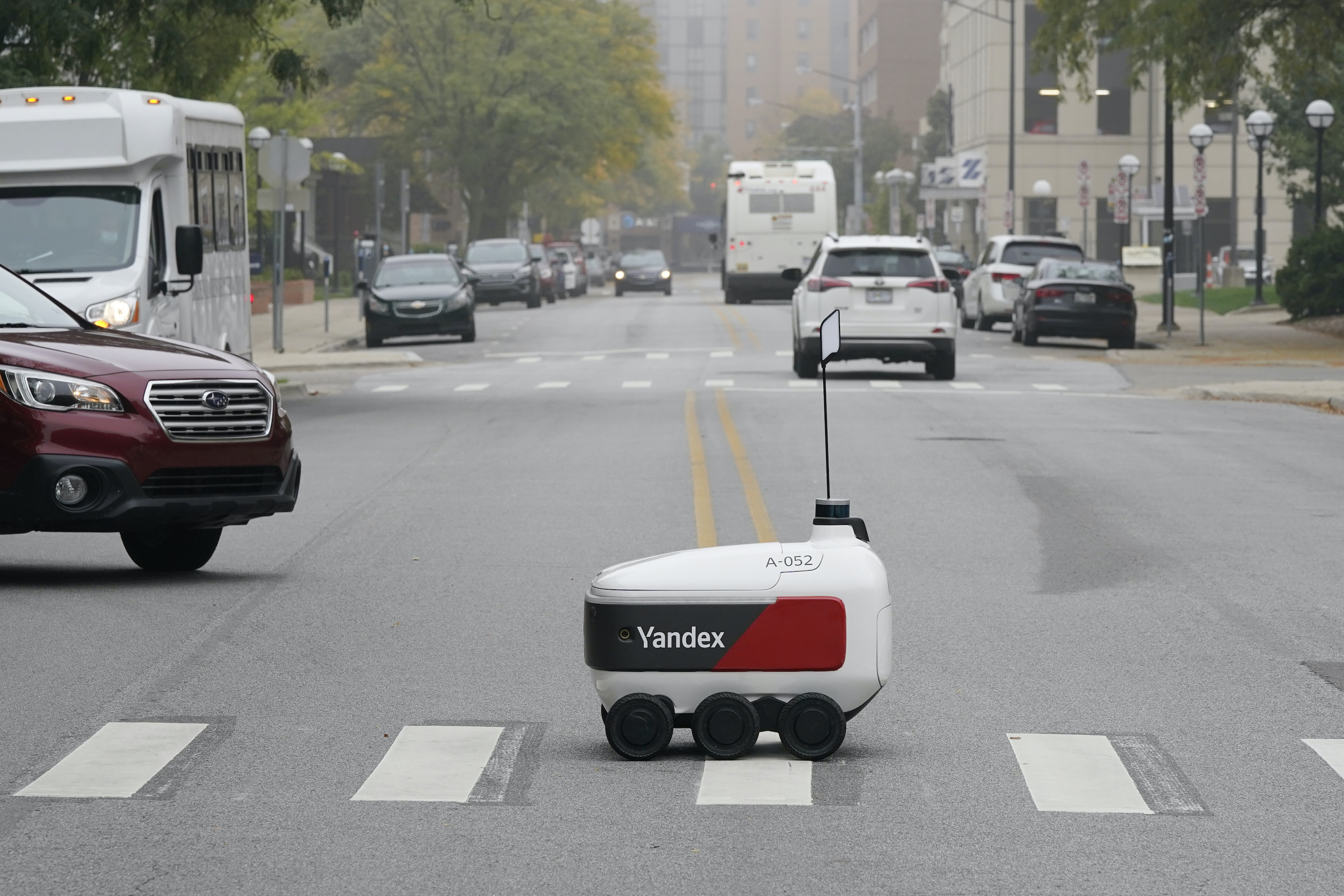 A food delivery robot crosses a street in Ann Arbor, Mich. on Thursday, Oct. 7, 2021.