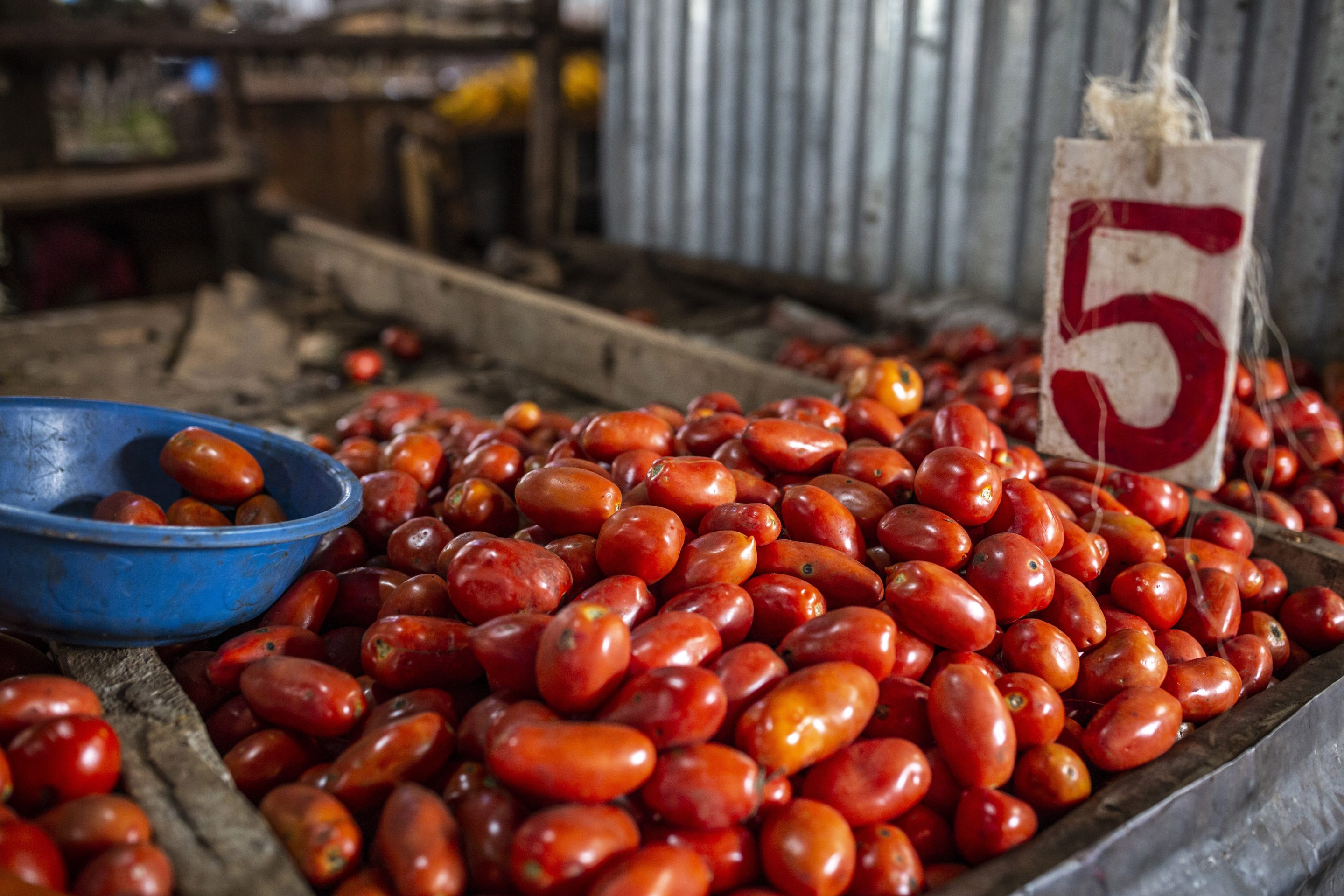 Fresh tomatoes for sale on a stall at Toi Market in Nairobi.