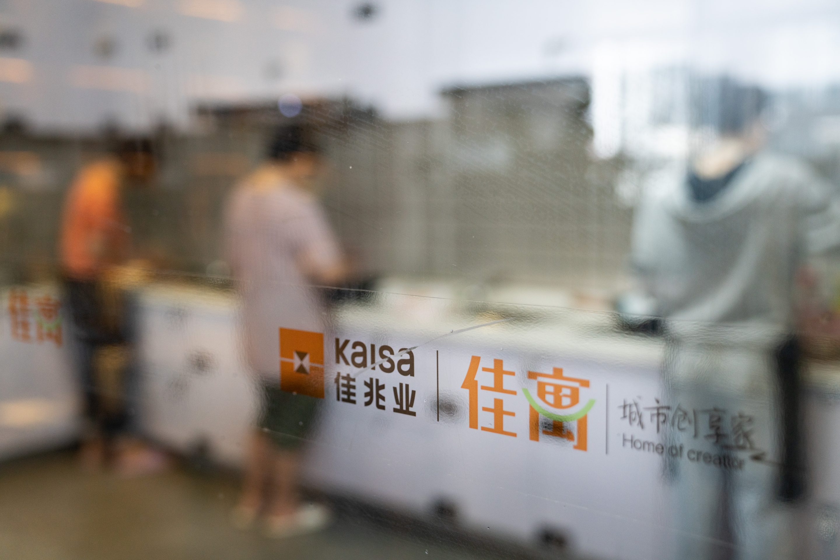 Signage on a glass wall in the communal kitchen at Kaisa Group Holdings Ltd.'s Home of Creator residential development in Shenzhen, China, on Nov. 21, 2020.  