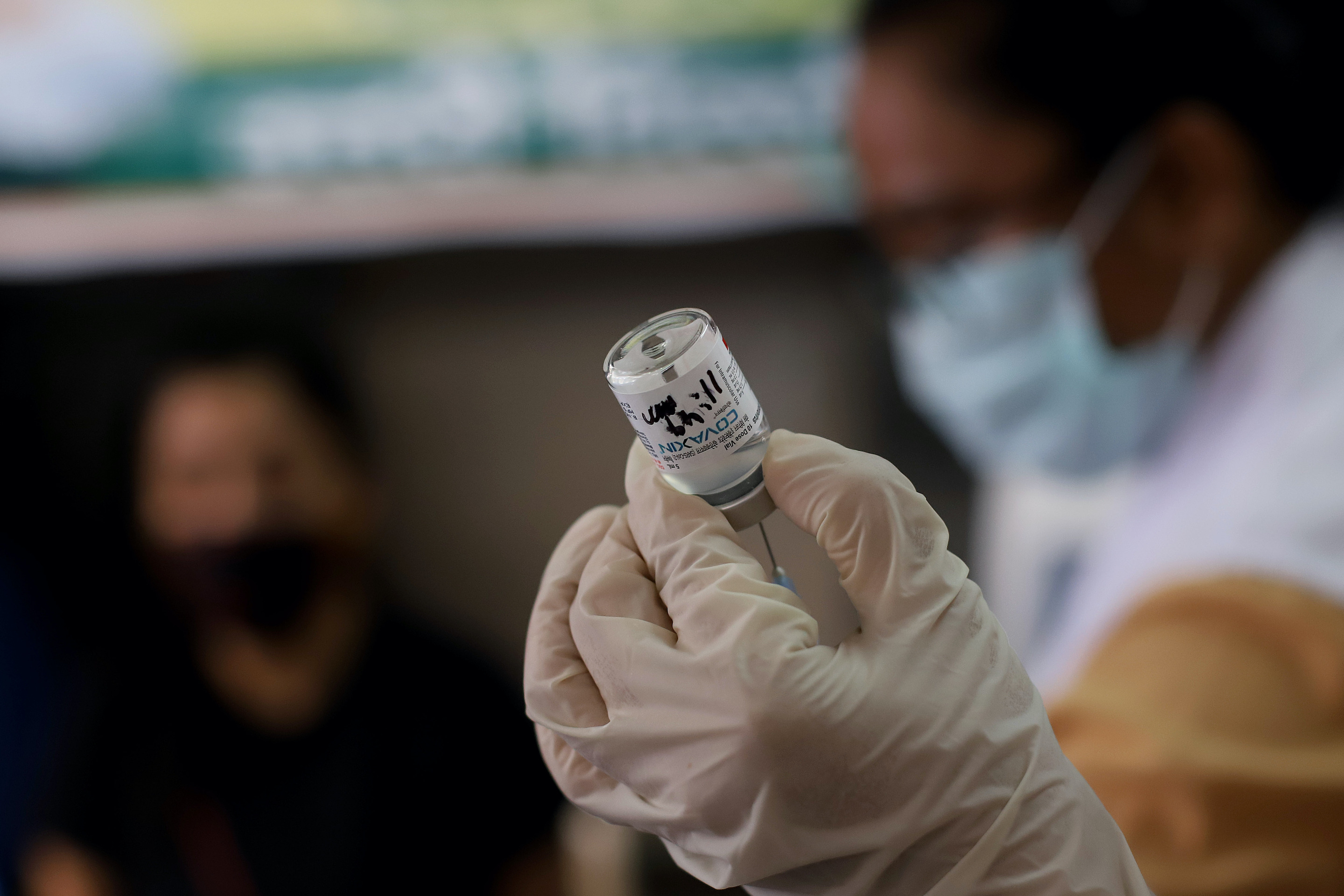 A health worker draws a dose of the Covaxin vaccine into a syringe during a vaccination against the Covid-19 coronavirus at a health centre, as India celebrate 1 billion doses of COVID-19 vaccination, in New Delhi India.