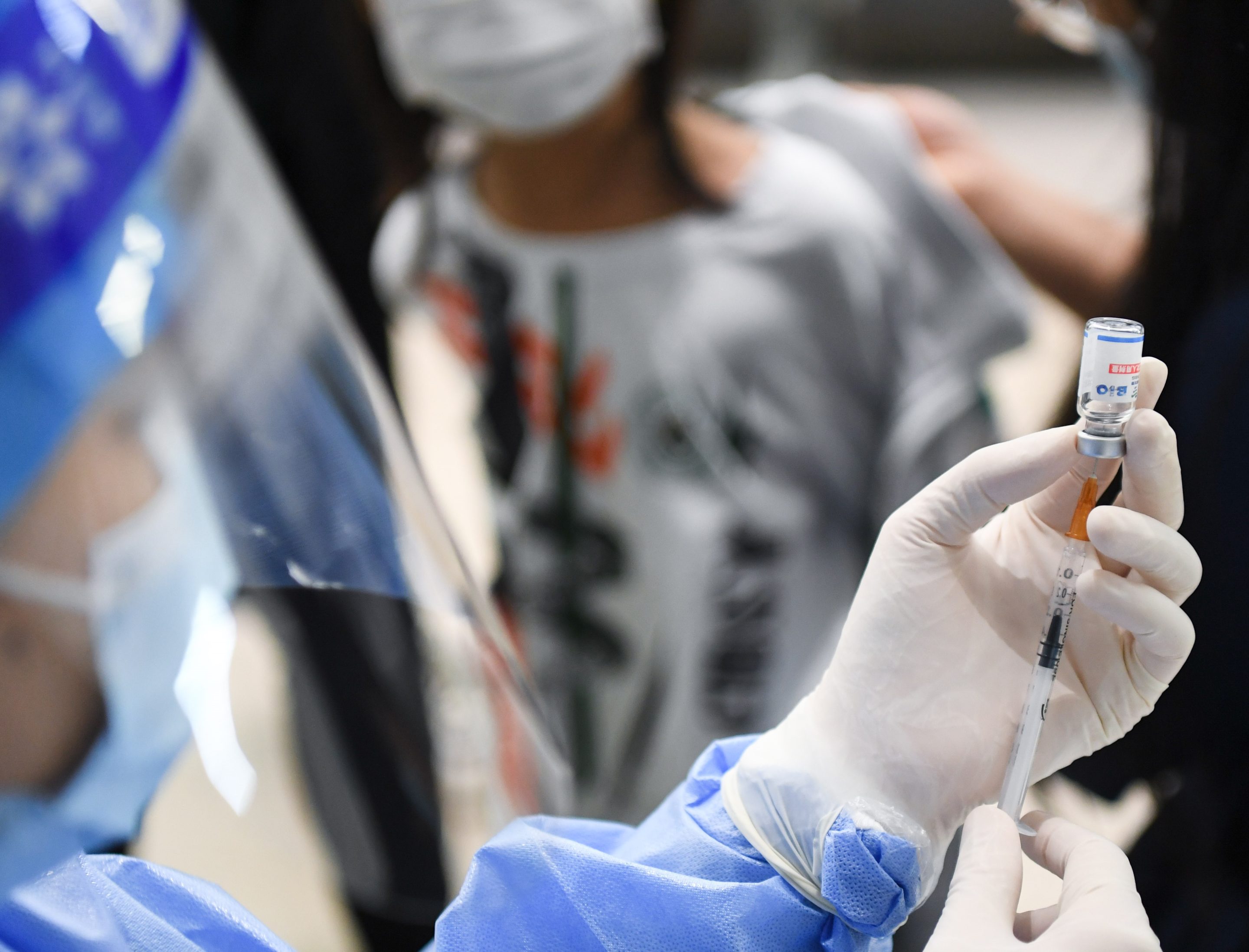 A medical worker prepares for COVID-19 vaccination at a primary school in Guangzhou on Nov. 1, 2021.