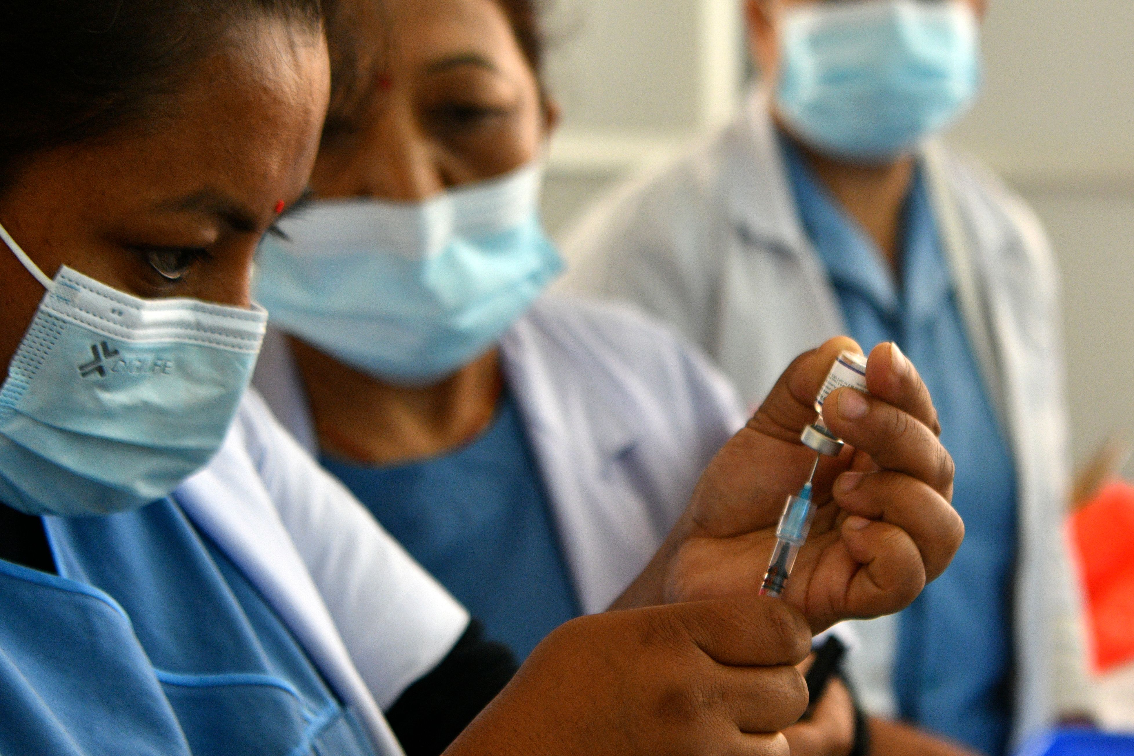 A health worker prepares to inoculate a person with the Pfizer-BioNTech vaccine in Kathmandu on Nov. 14, 2021.