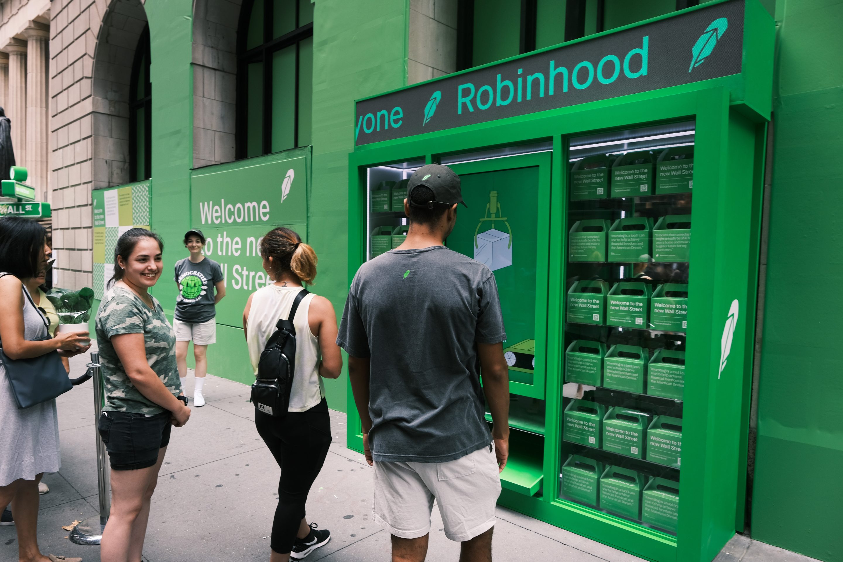People wait in line for t-shirts at a Robinhood-sponsored pop-up kiosk along Wall Street on July 29 after the stock-trading app went public with an IPO earlier in the day.