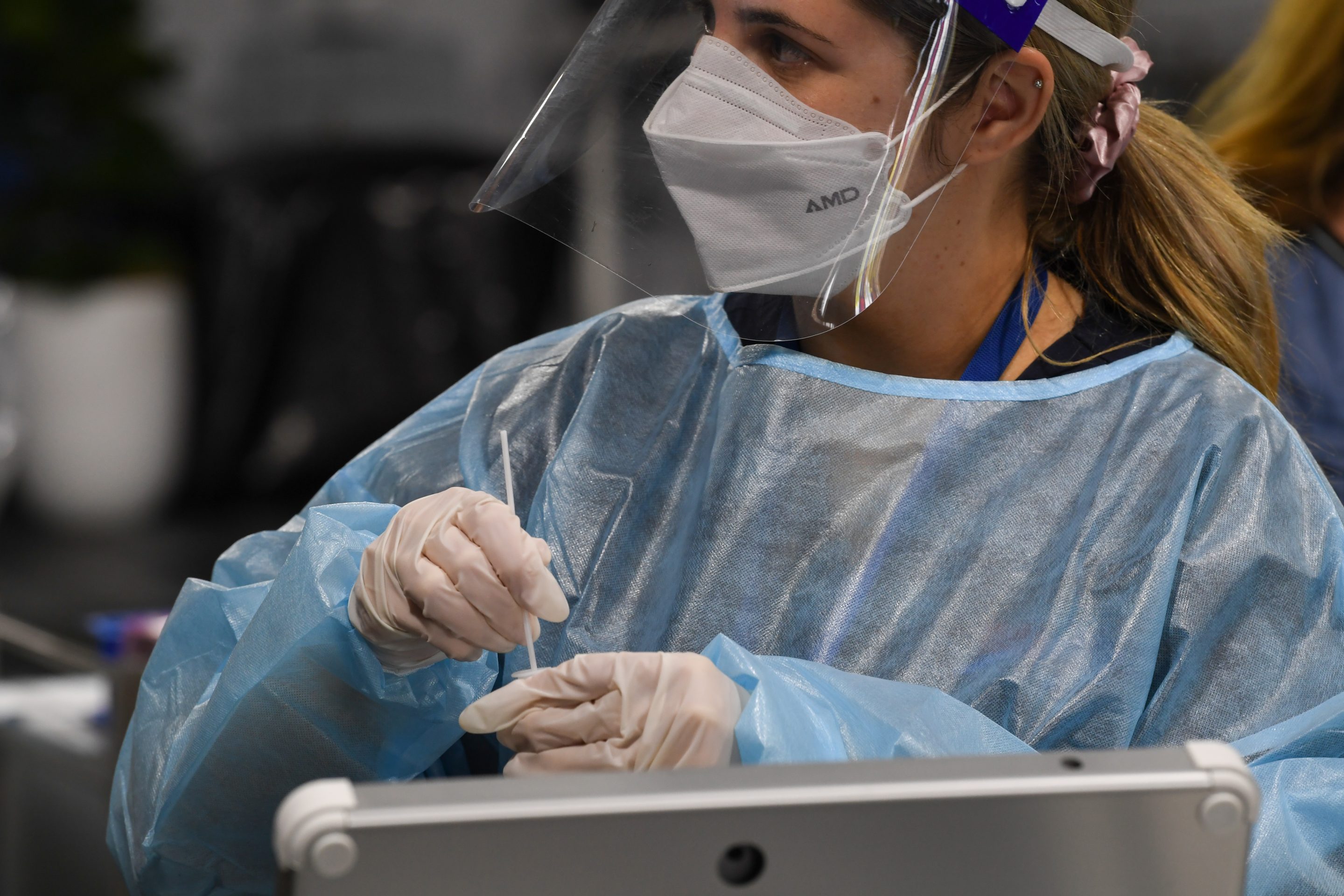 A health staff member prepares a COVID-19 test at the Histopath Diagnostic Specialists pre-departure area at Sydney International Airport on Nov. 28, 2021.