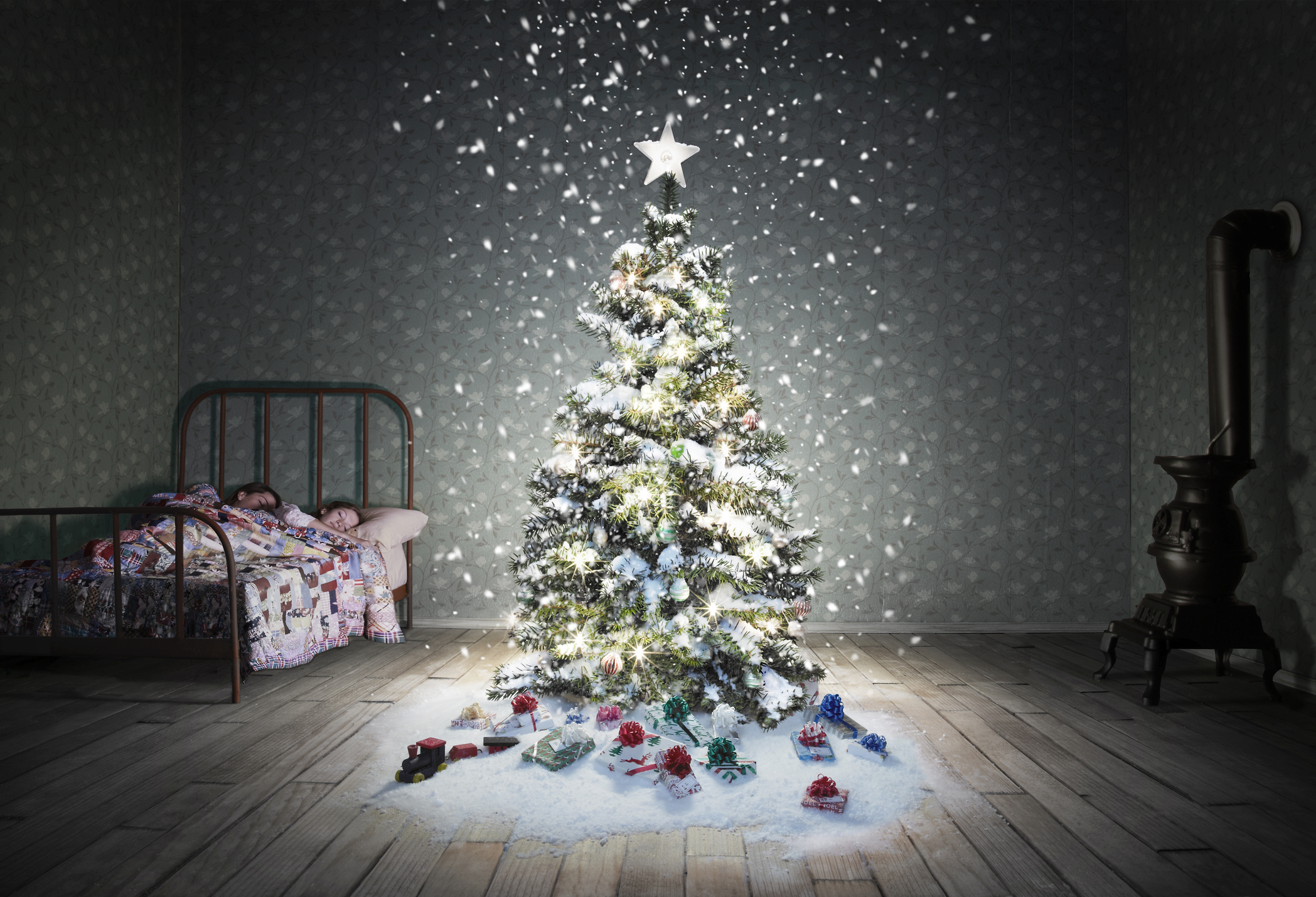 A classic children's bedroom with a glowing decorated Christmas tree.