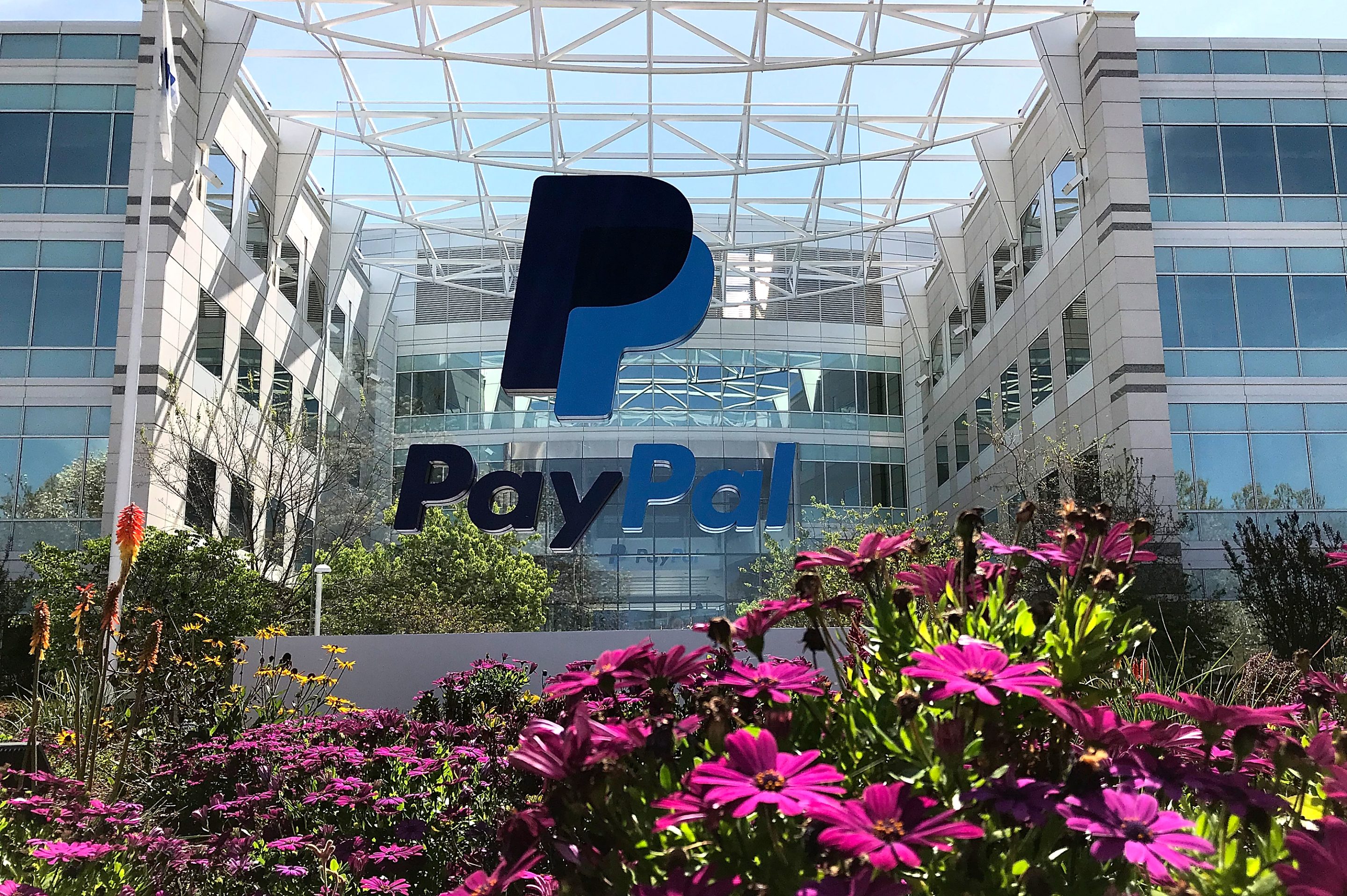 A sign is posted outside of the PayPal headquarters on April 9, 2018 in San Jose, California. Paypal's stock dropped nearly 12% Tuesday after reporting lower-than-expected guidance for the fourth quarter.
