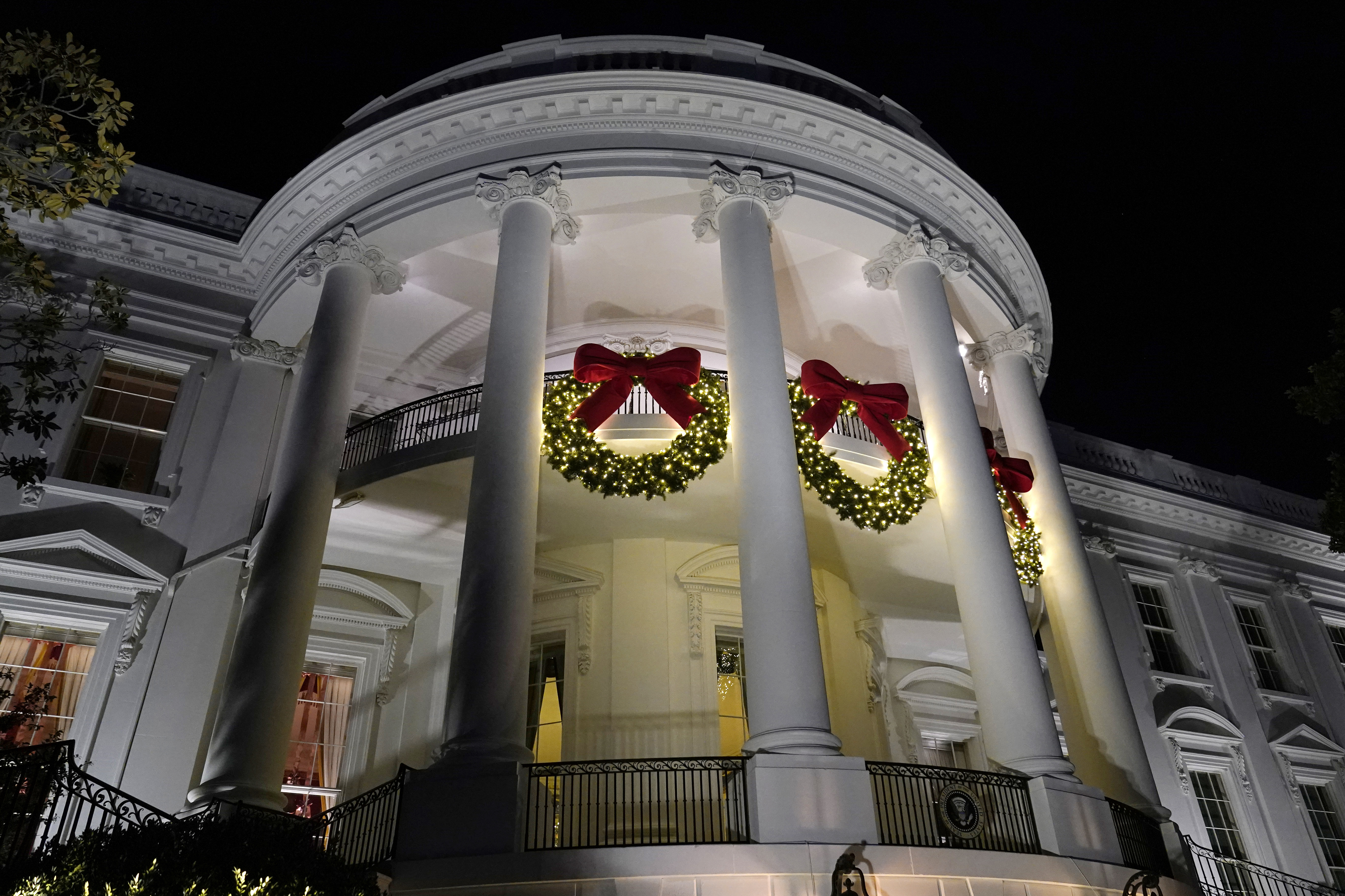 A view of the South balconies of the White House in Washington Nov. 30, 2021, lit up with holiday decorations. In addition to fewer people passing through the White House for the open houses, thousands of other people didn't get a close-up look at how Jill Biden decked out White House hallways and public rooms for the holidays because public tours of the executive mansion remain on indefinite hold due to COVID-19.