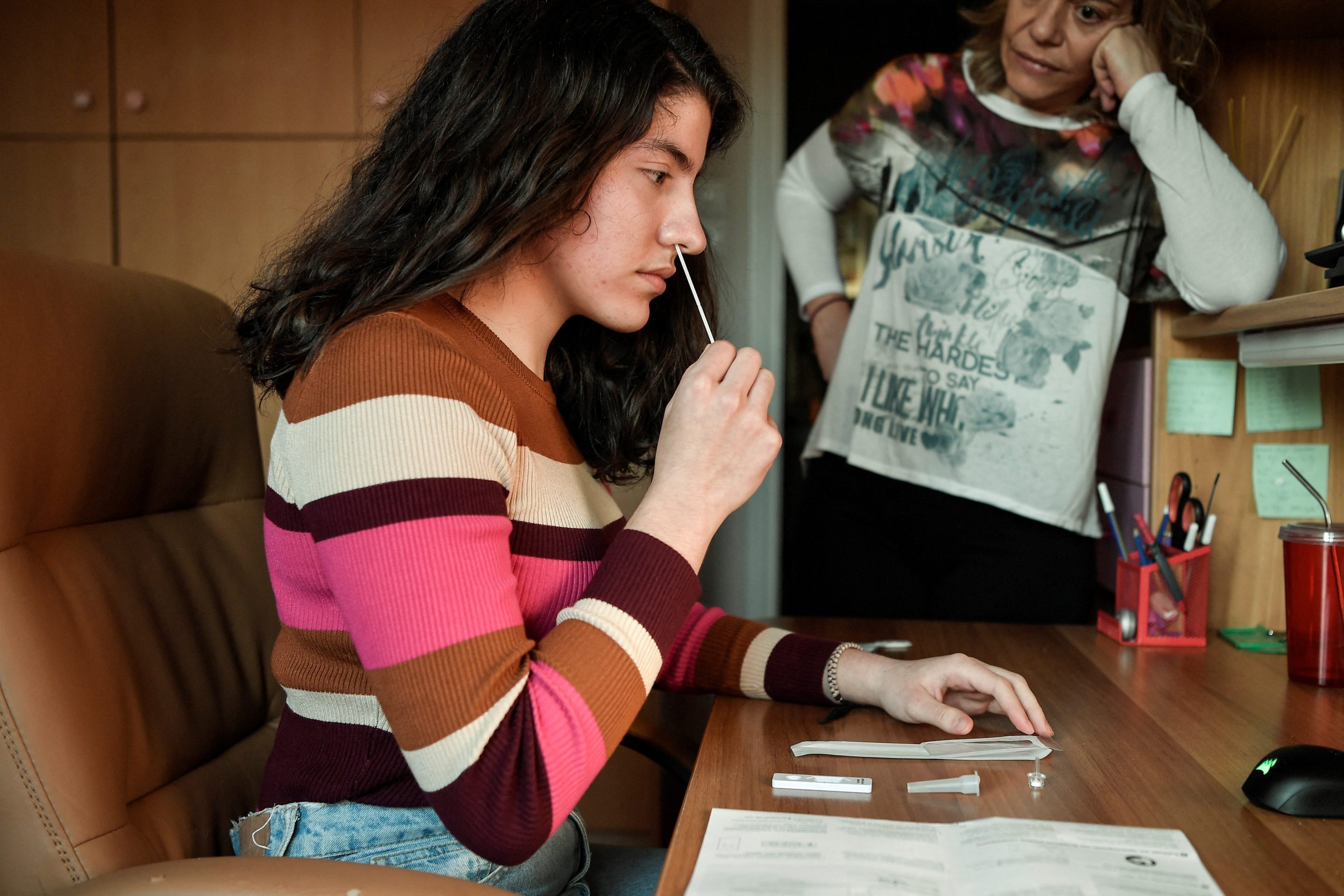A student in Greece performs an at home Covid-19 test.