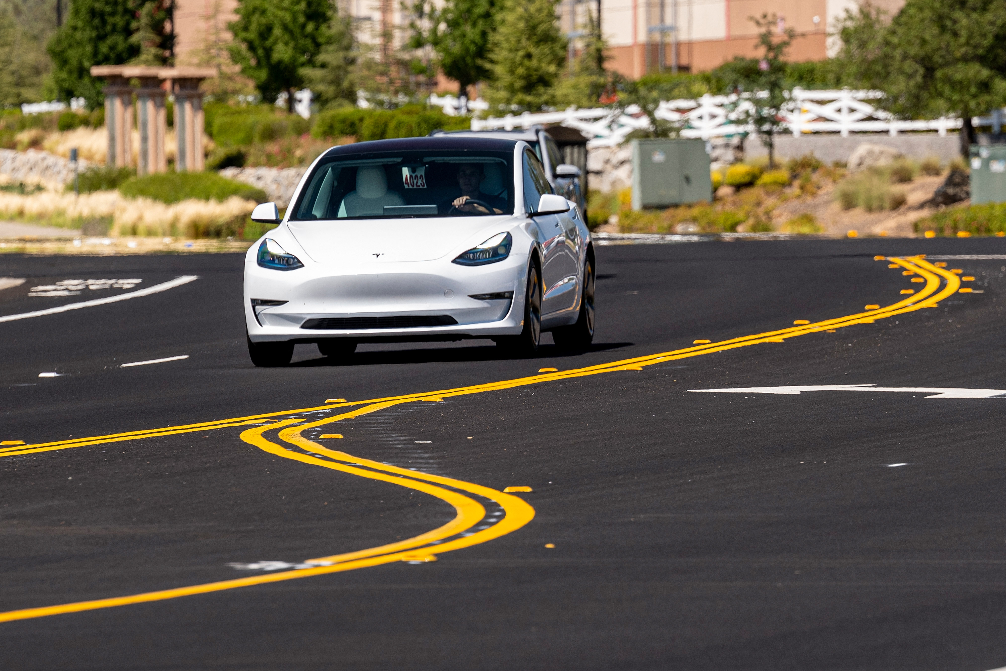 A Tesla Model 3 travels on a road in Rocklin, Calif. on July 21, 2021.