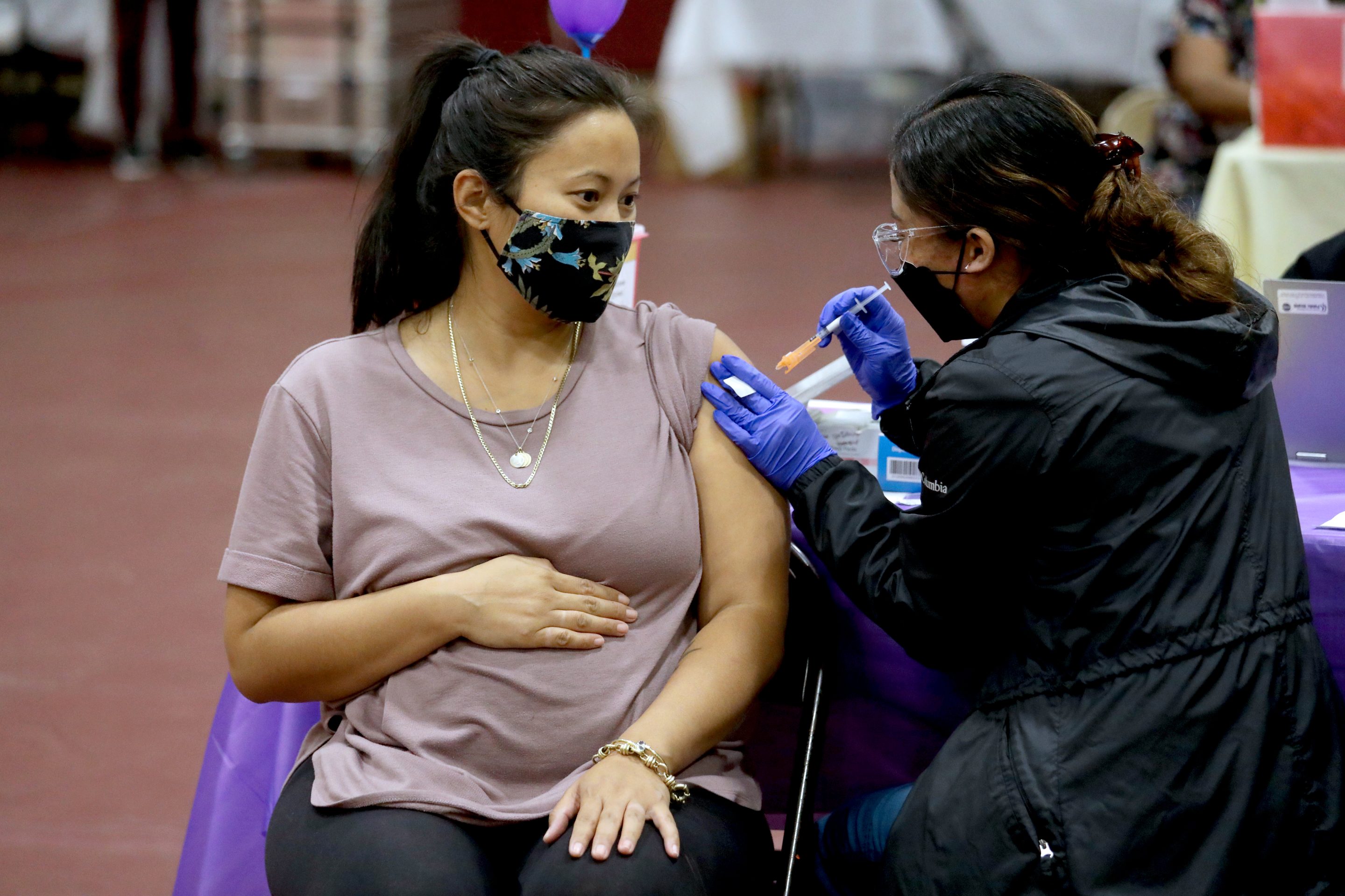 Nicole Fahey, of Altadena, six months pregnant, receives a Pfizer vaccination booster shot from RN Veronique (cq) Vida (cq) at Eugene A. Obregon Park on Wednesday, Nov. 3, 2021 in Los Angeles, CA.