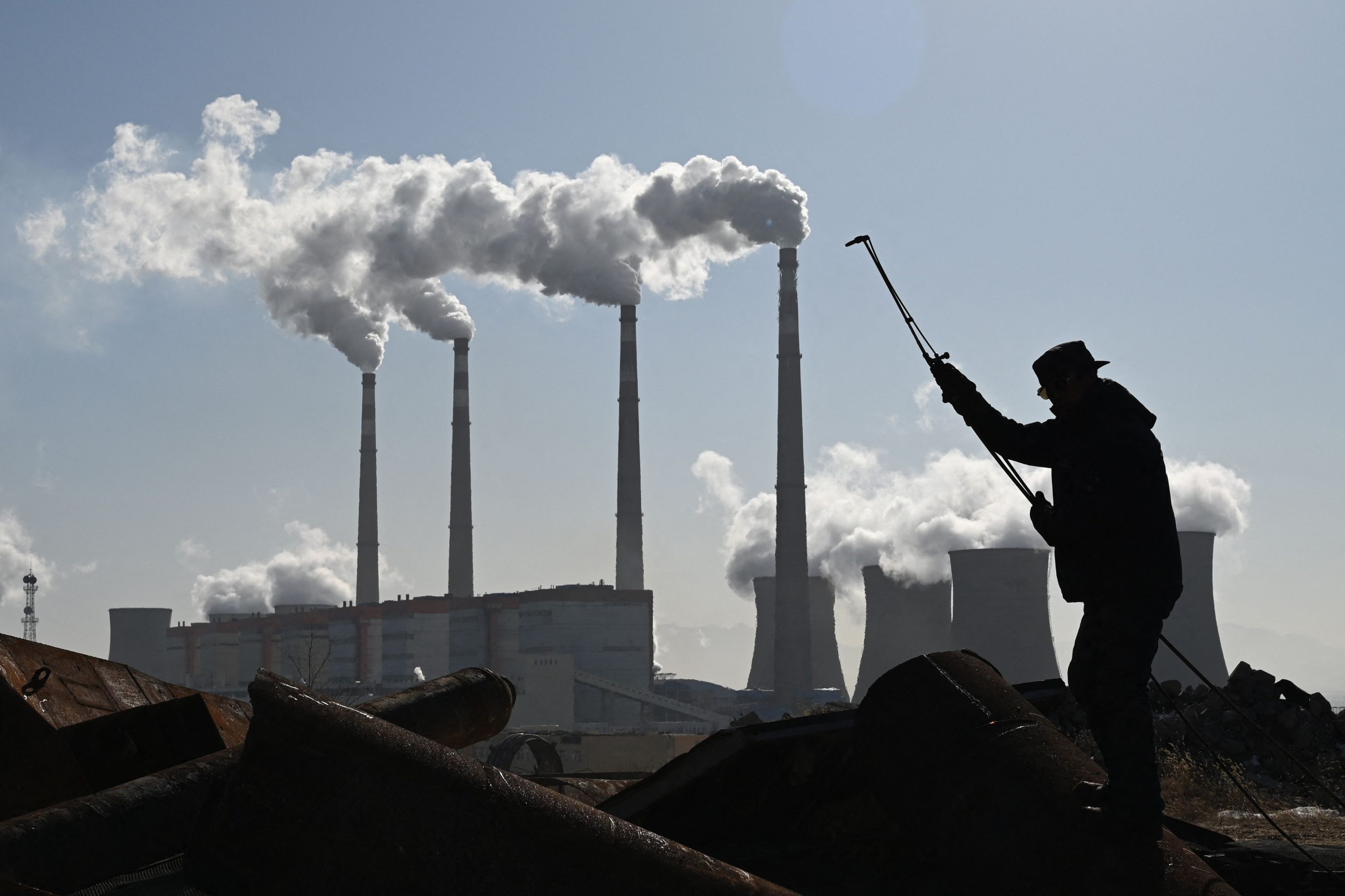 A worker cutting steel pipes near the coal-powered Datang International Zhangjiakou Power Station in China’s Hebei province in November.