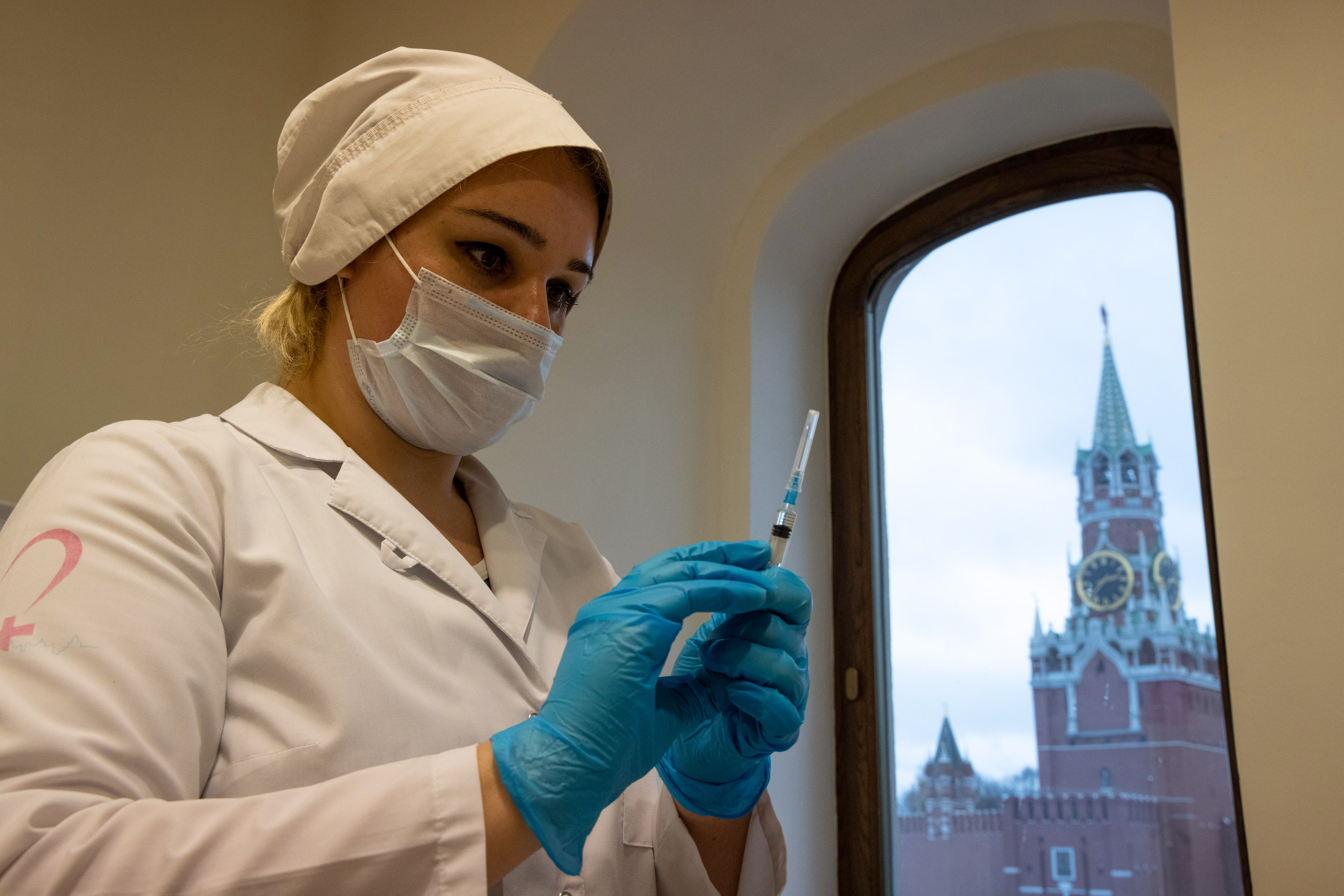 A health worker prepares a dose of the Sputnik V vaccine at a Covid-19 vaccination center inside the GUM luxury department store in Moscow, Russia, on Nov. 12, 2021.