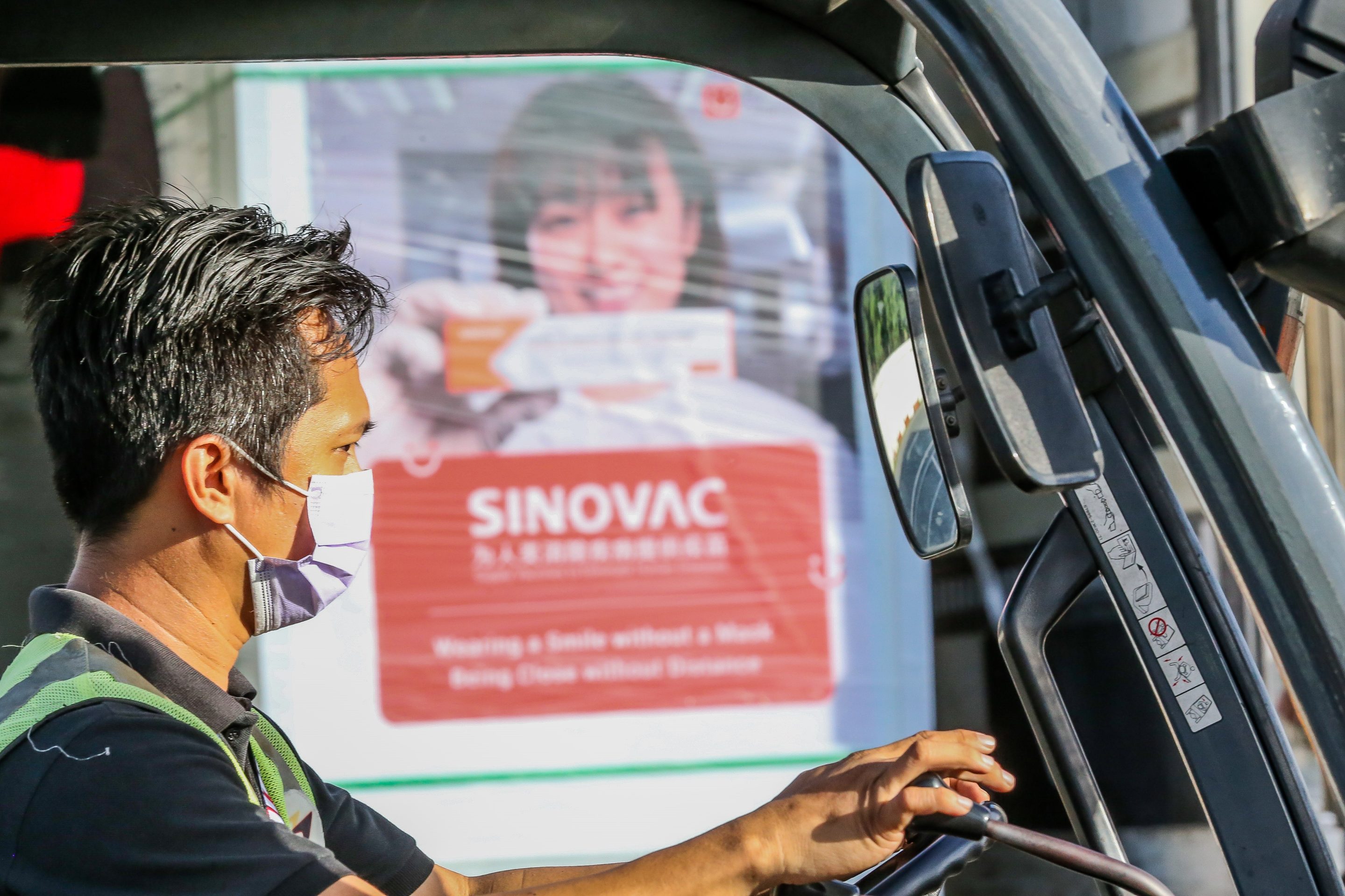 A staff member transports a cargo containing Sinovac vaccines in Pasay City, the Philippines on Nov. 17, 2021.