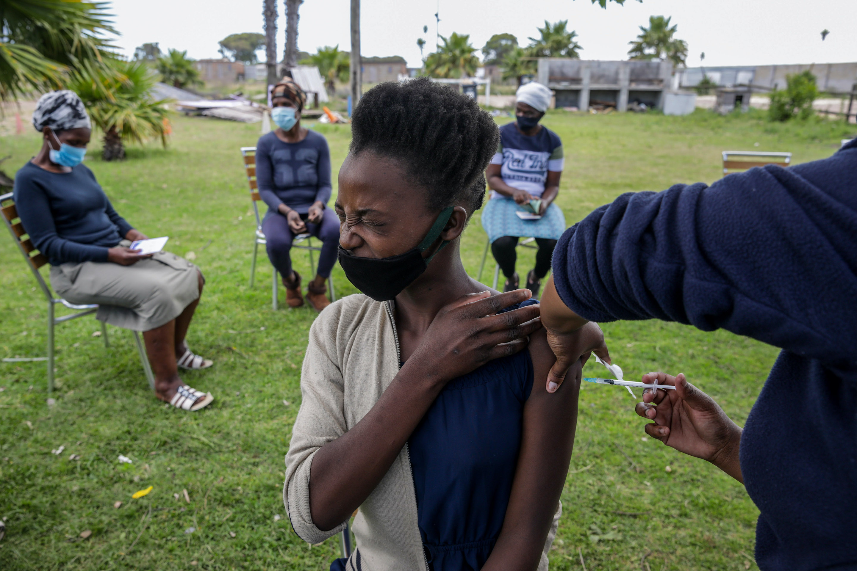 A health worker administers a dose of the Pfizer-BioNTech Covid-19 vaccine at CAFDA (Cape Flats Development Association) in the Egoli township of Cape Town, South Africa on Nov. 30, 2021.
