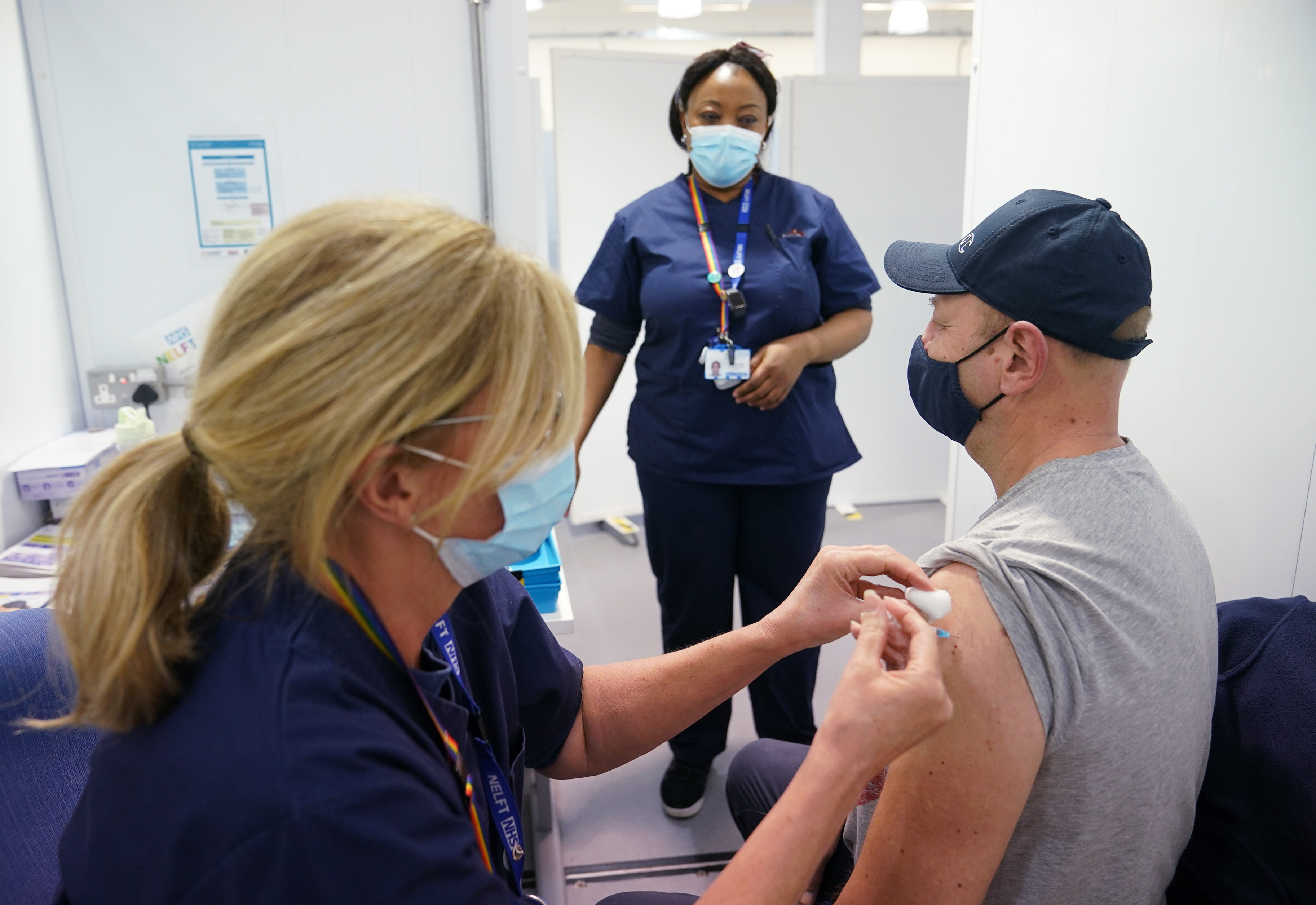 A member of the public receives the Pfizer COVID-19 vaccination at a vaccination site in Liberty Shopping Centre, Romford, east London, as the Government accelerates the Covid booster program to help slow the spread of the new Omicron variant.
