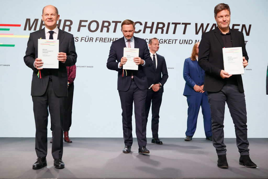 Olaf Scholz (left) is taking the lead as chancellor of Germany's new three-party coalition government.