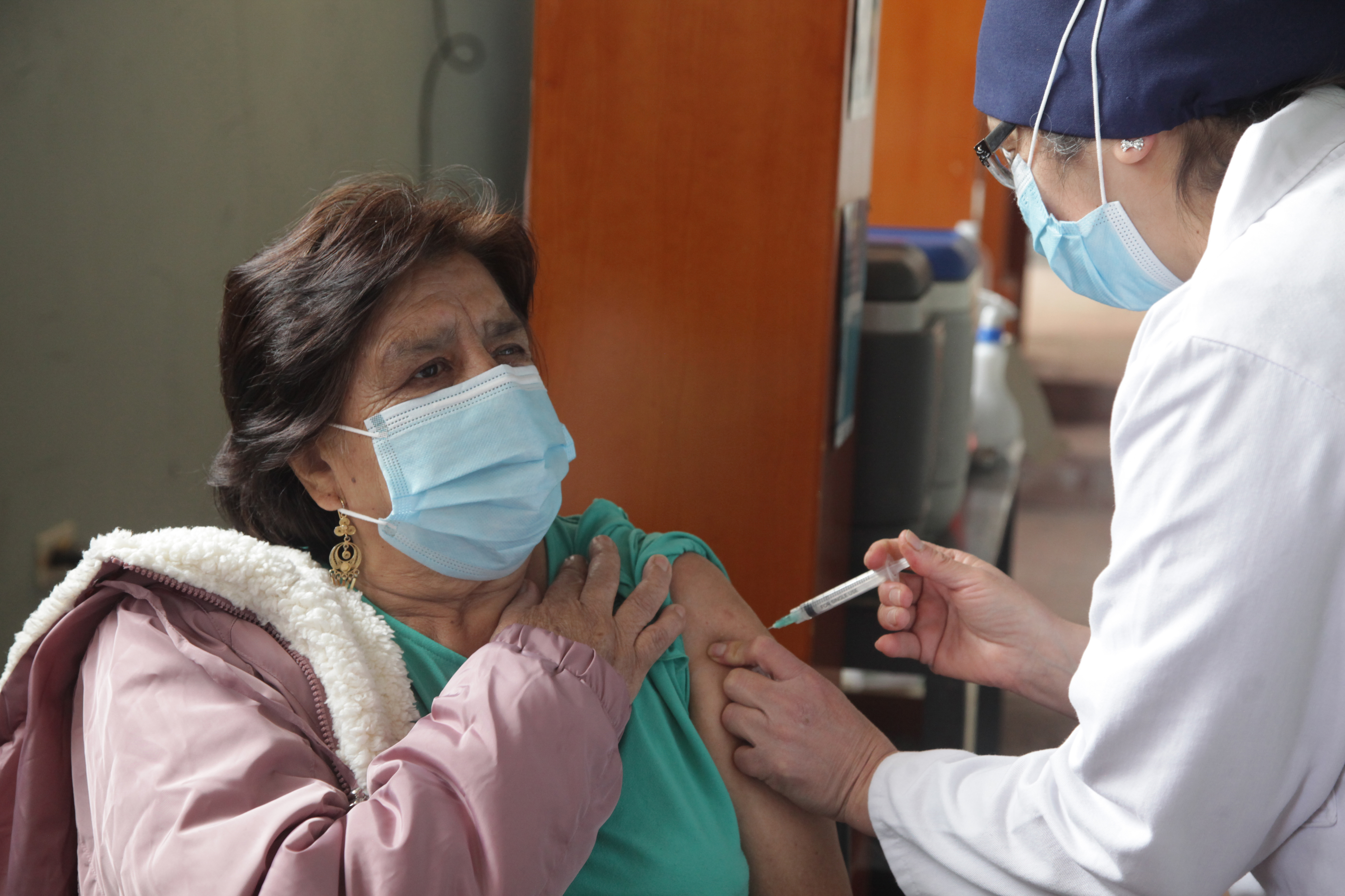 A health worker administers a dose of AstraZeneca vaccine in Cuenca, Ecuador.