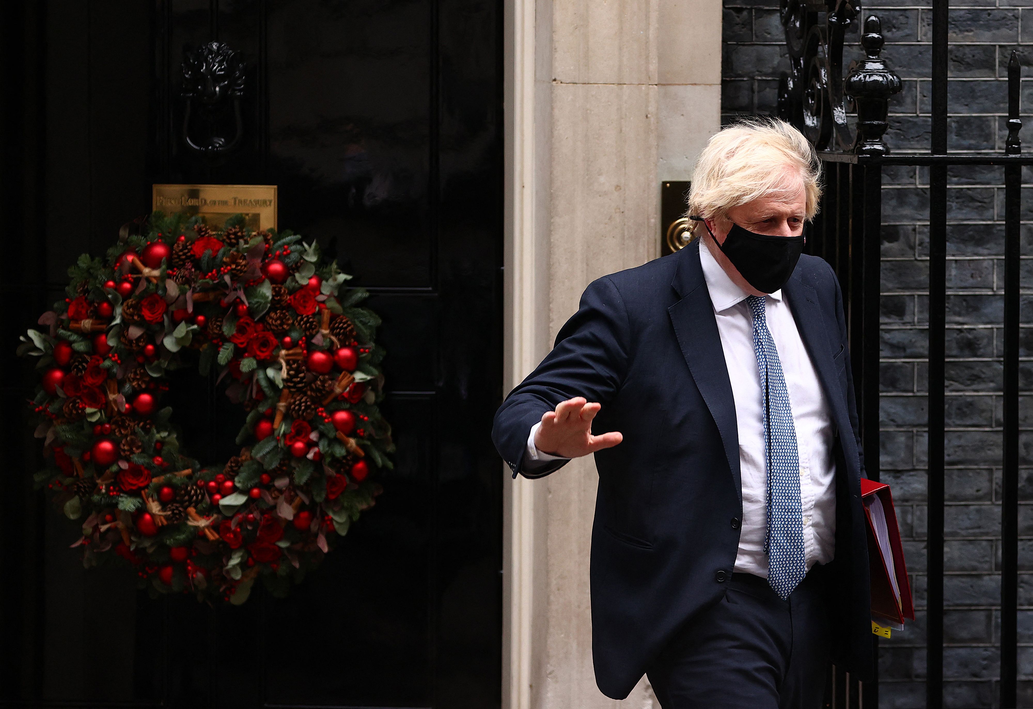 Britain's Prime Minister Boris Johnson, wearing a face covering to stop the spread of coronavirus, leaves from 10 Downing Street in central London on December 8, 2021,