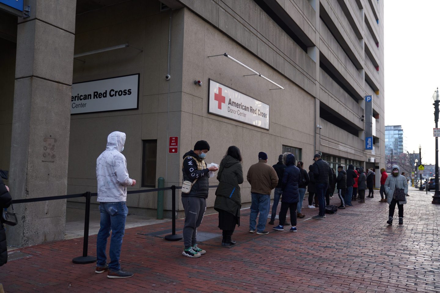 Boston residents wait in line to receive a COVID-19 test.