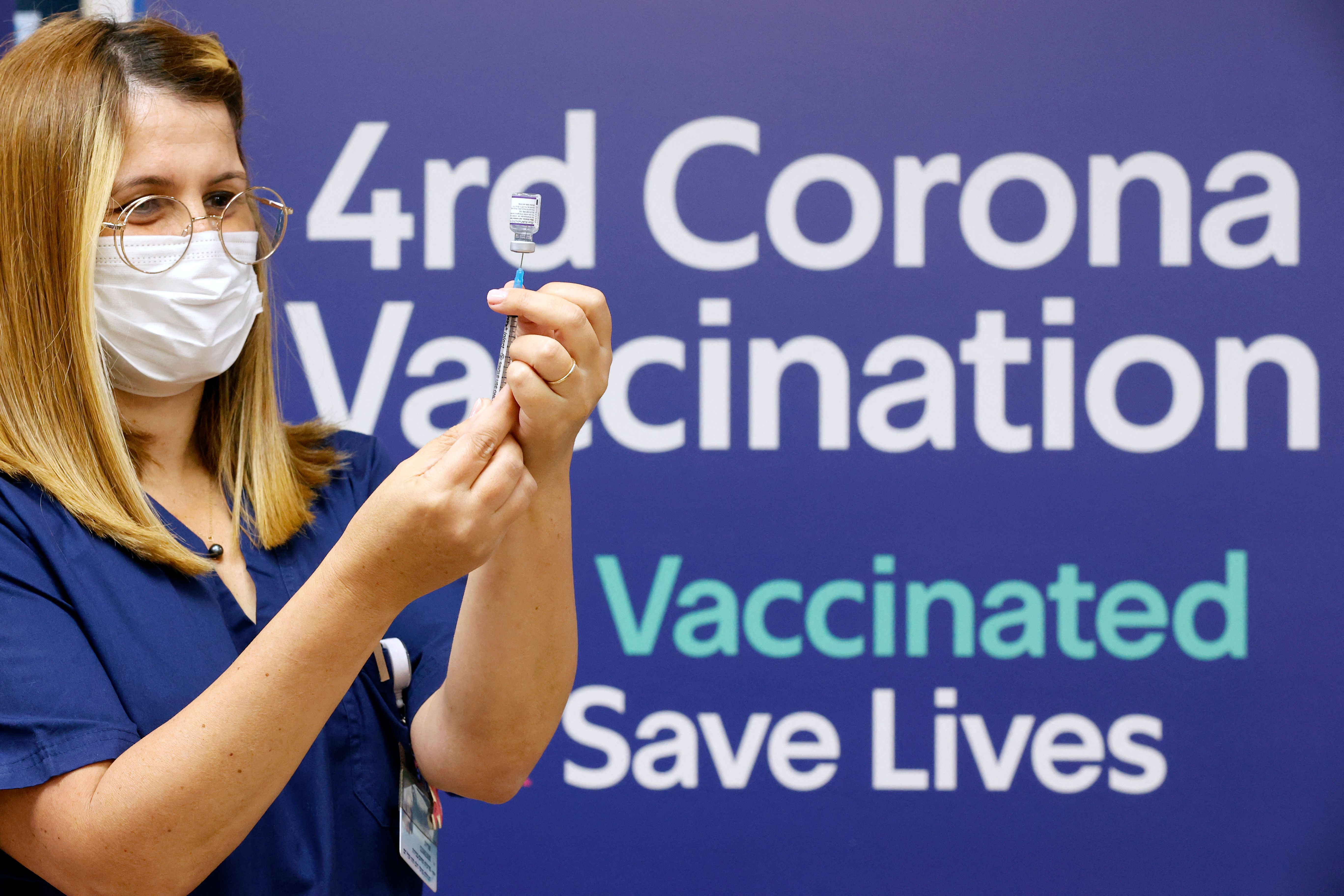 A medic prepres a dose of the Pfizer-BioNTech vaccine against the coronavirus, to be used as a fourth shot, at the outpatient clinics of the cardiovascular centre at Sheba Medical Center in Ramat Gan, near the Israeli city of Tel Aviv, on Dec. 31, 2021.