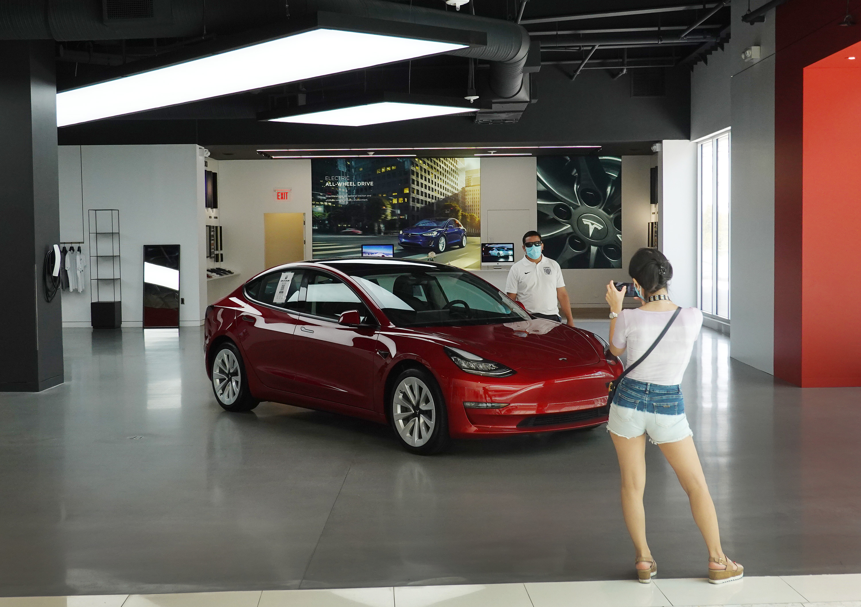 A Tesla vehicle is on display at a showroom in the Aventura Mall in Miami, Florida. According to the National Highway Traffic Safety Administration, the company will send out a software update over the Internet so the function called “Passenger Play” will be locked and won't work while vehicles are in motion.