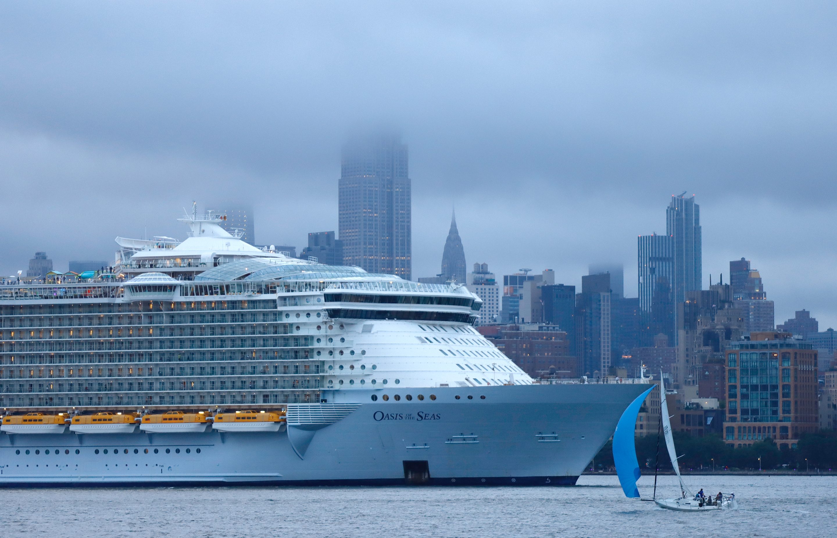 Royal Caribbean Oasis of the Seas cruise ship sails up the Hudson River for a photo opportunity in front of the Empire State Building in New York City on August 18, 2021 as seen from Jersey City, New Jersey.