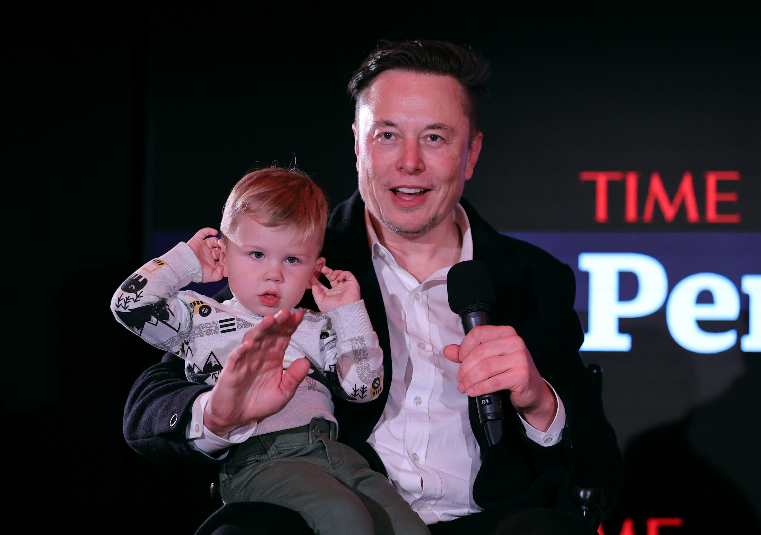 Elon Musk and son X Æ A-12 on stage as the Tesla CEO is named the TIME Person of the Year on Dec. 13, 2021 in New York City. 