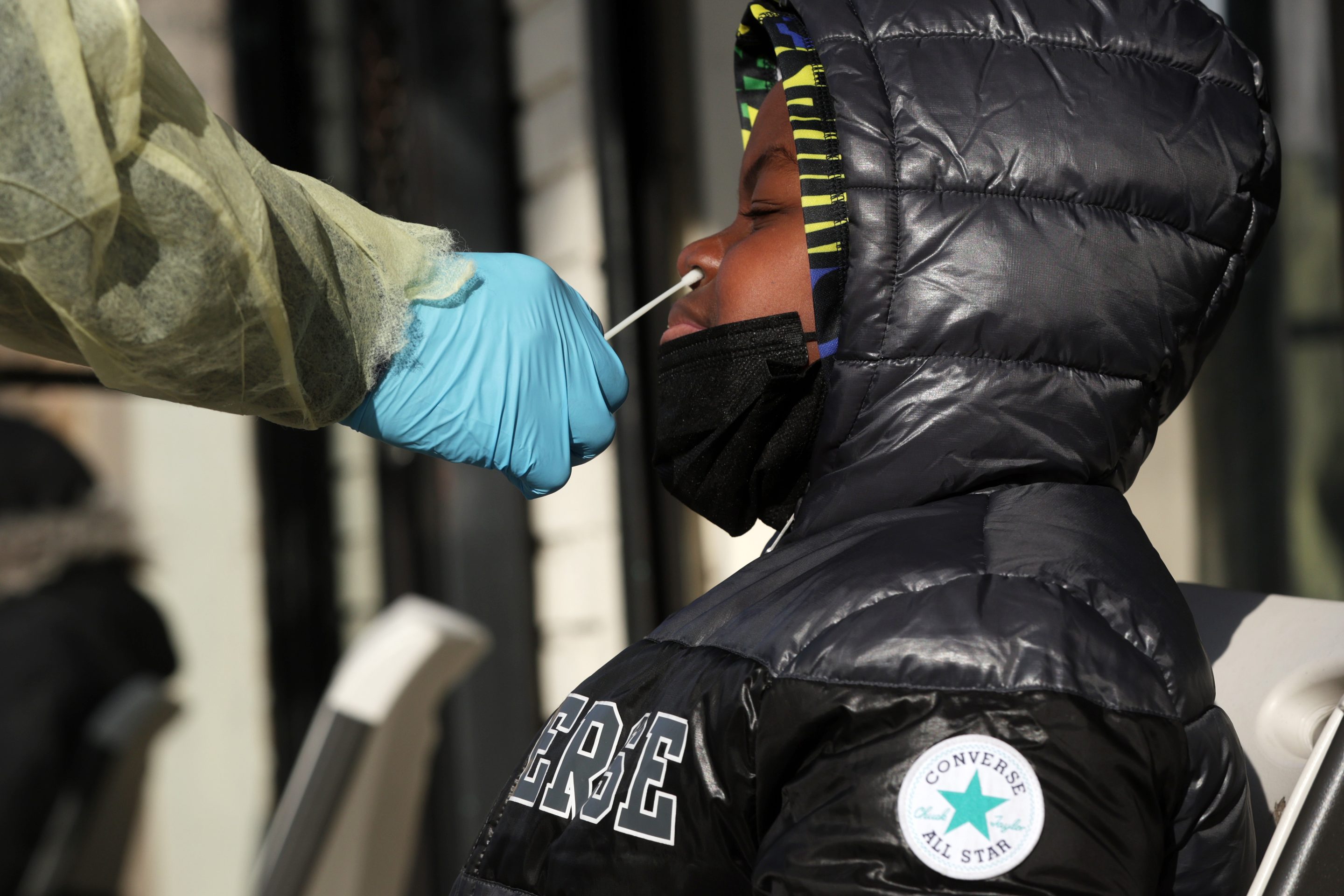 A patient takes a COVID test outside District Urgent Care on December 23, 2021 in Washington, DC.