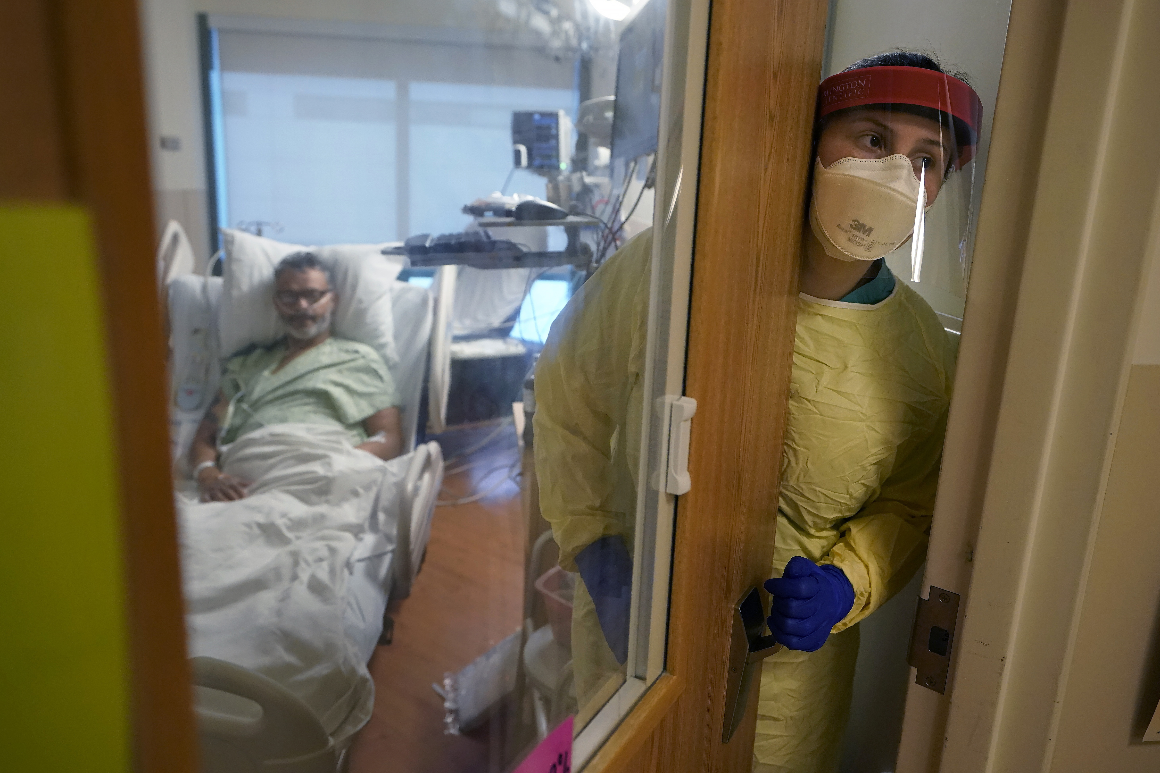 A nurse attends to a COVID patient.