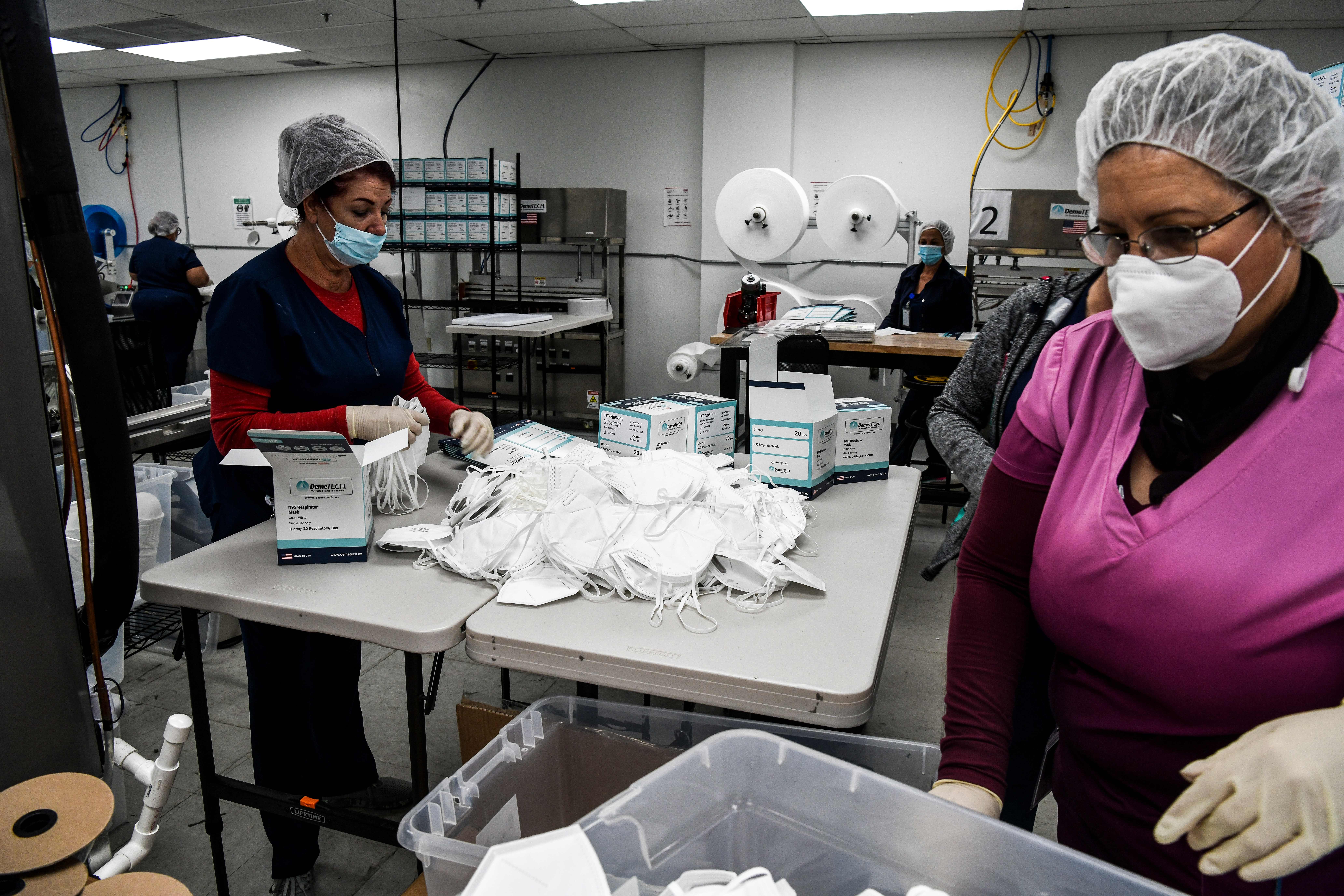Employees make respiratory masks at a family-owned medical equipment factory in North Miami on Feb. 15, 2021.