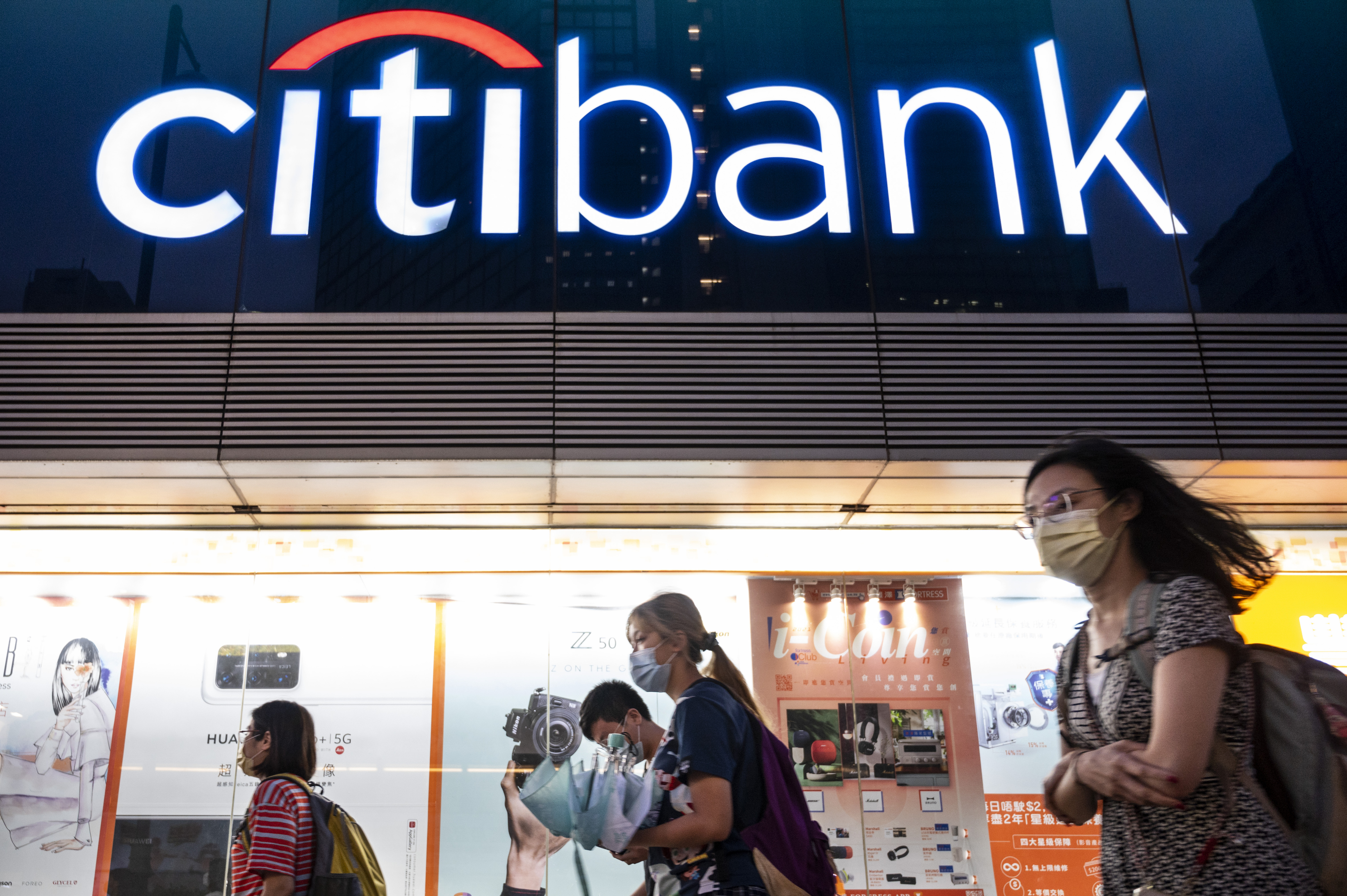 People walk by a Citibank branch in Hong Kong.