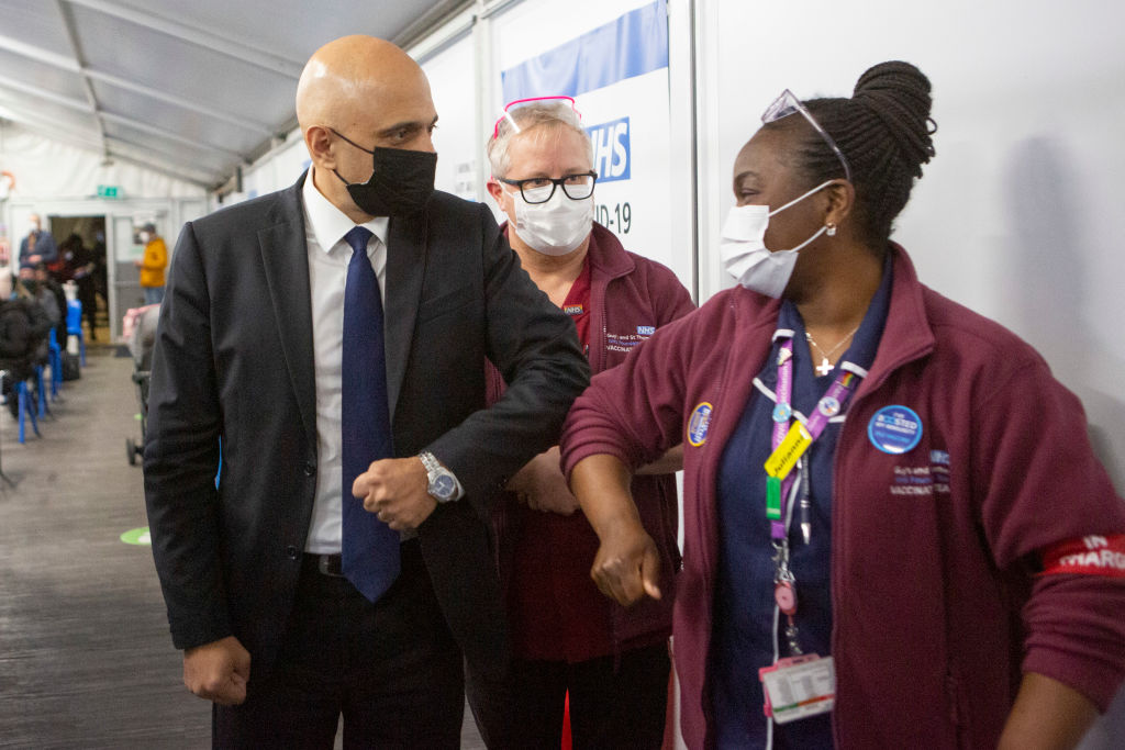 British Health Secretary Sajid Javid (left) urges caution against Omicron as the U.K. lifts COVID restrictions.