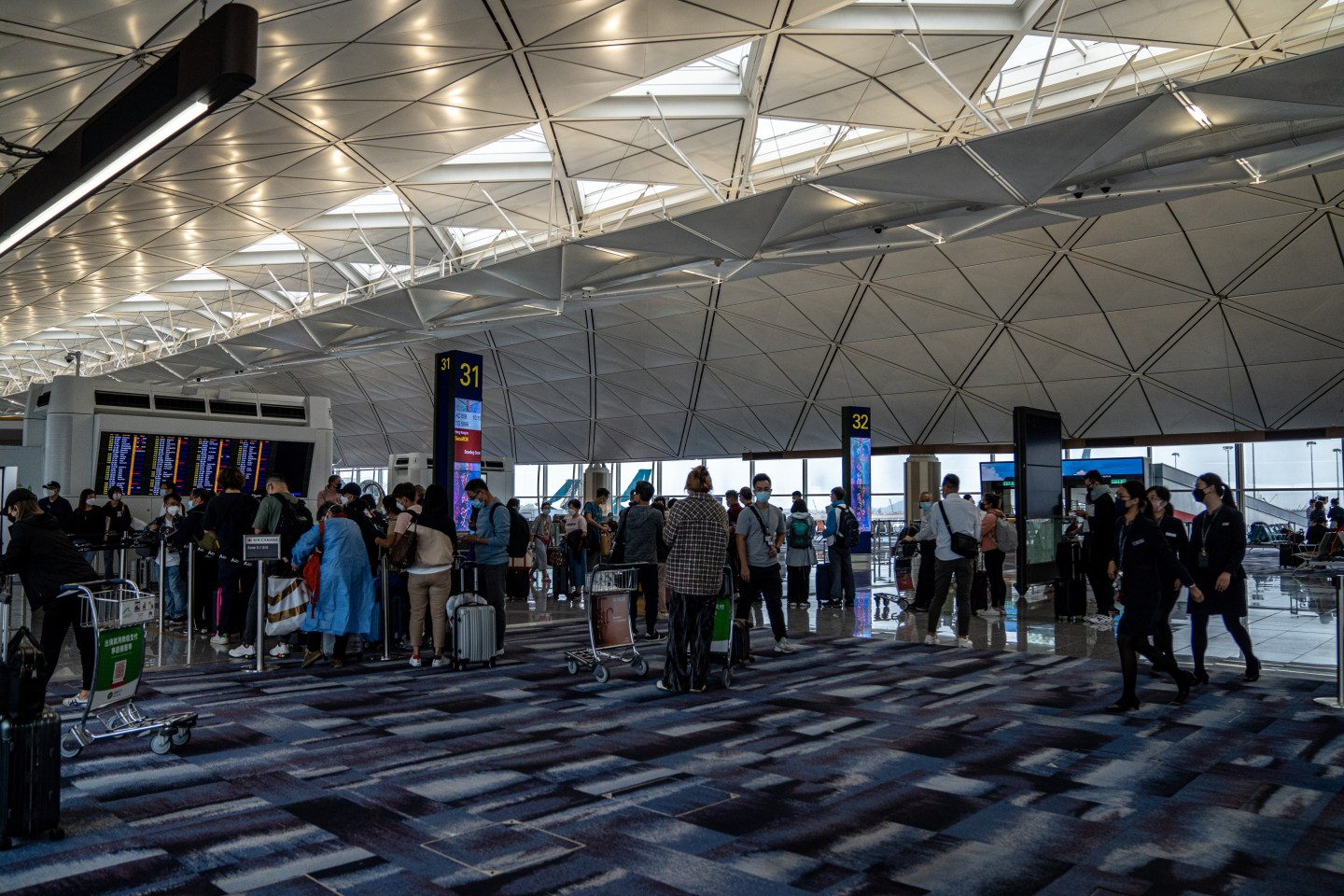 Hong Kong cuts quarantine for arrivals to 14 days—but extends its entry ban on 8 countries