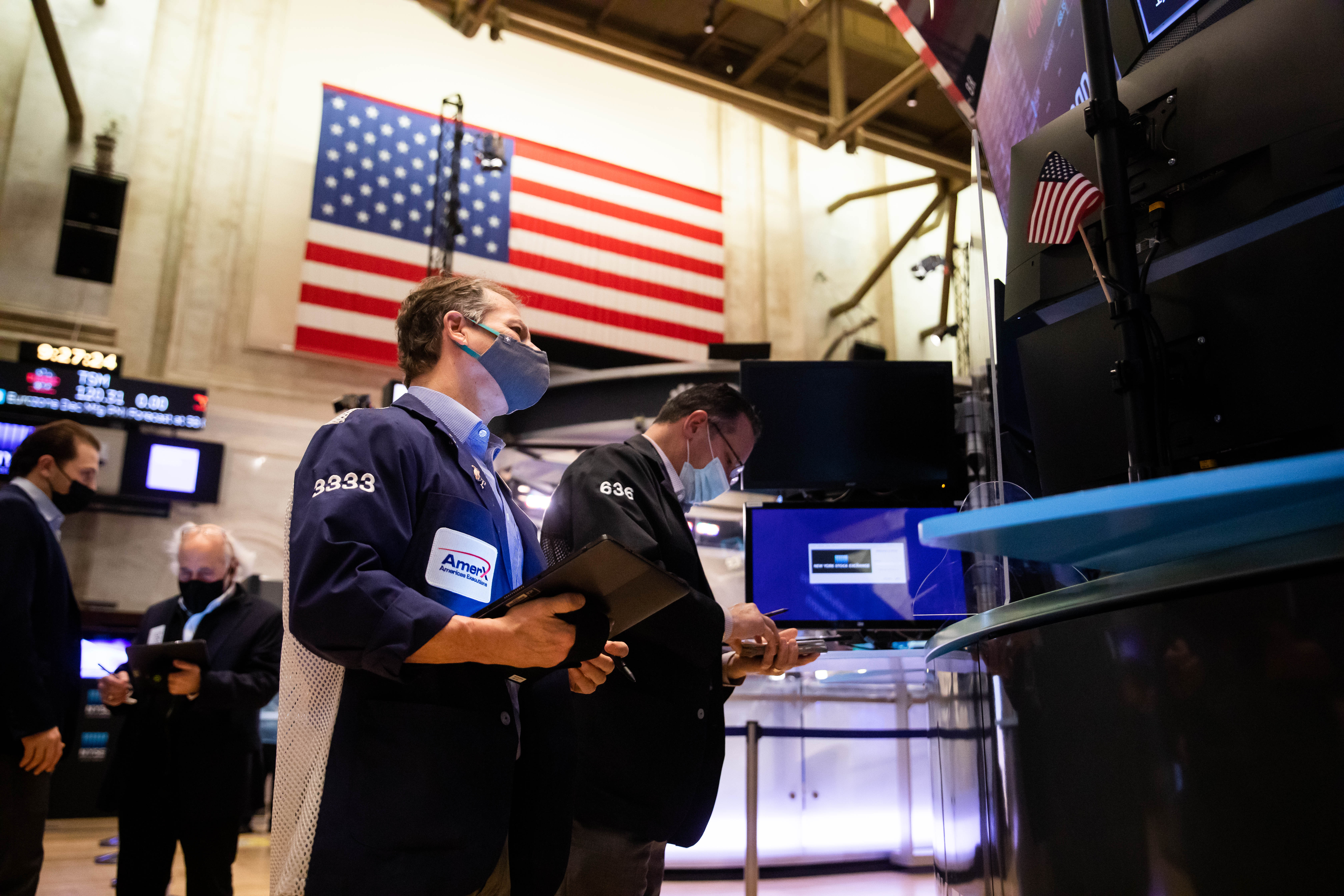 Traders work on the floor of the New York Stock Exchange (NYSE) on Monday, Jan. 3, 2022.