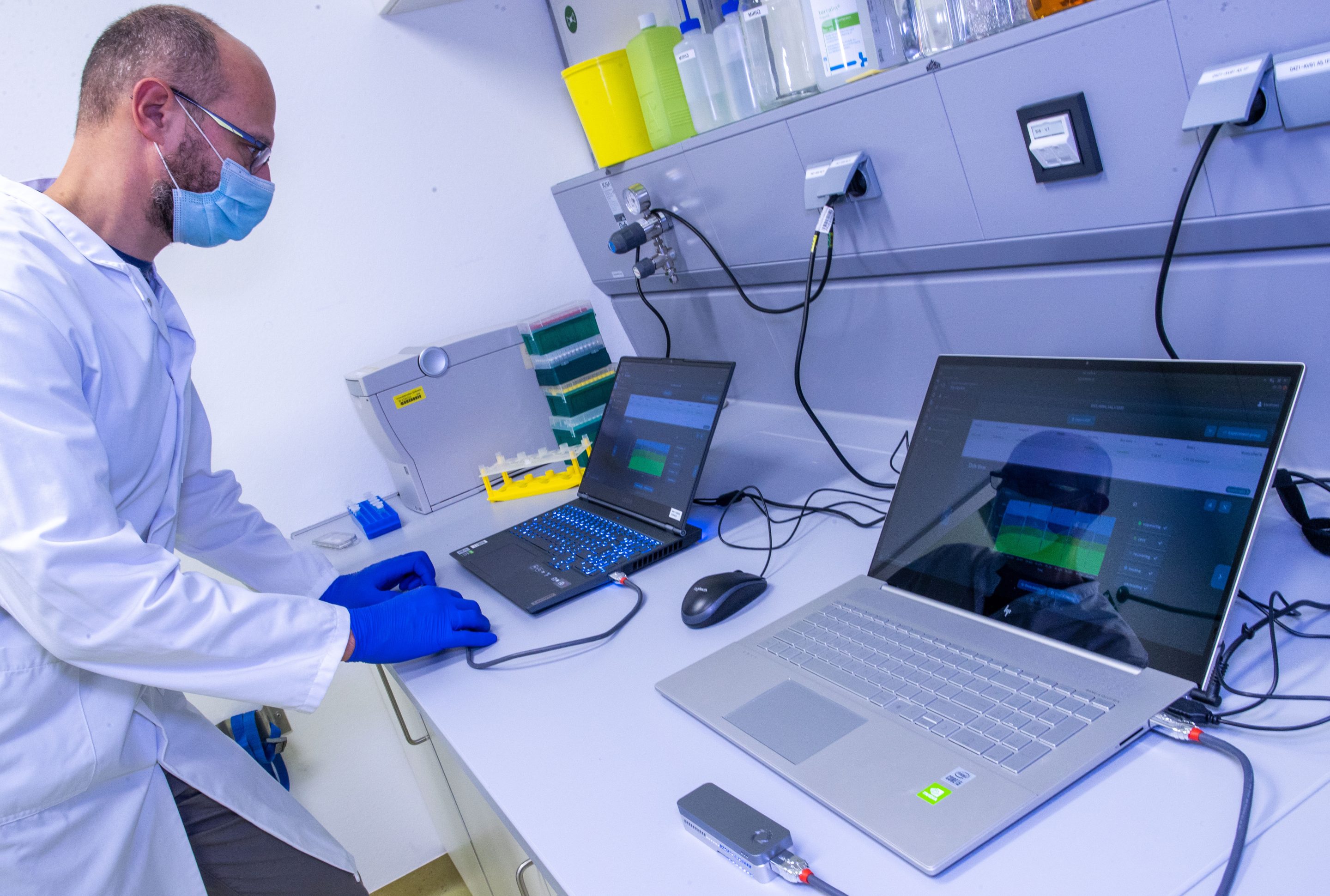 05 January 2022, Mecklenburg-Western Pomerania, Greifswald: Christian Kohler inserts a total of twelve samples into a sequencer with an elongated board in the laboratory for corona variants (CoMV gene) at Greifswald University Medical Center in search of new variants and mutations of the corona virus. The sequencer delivers 50 to 100 gigabytes of data, which then have to be analyzed on the computer for hours. Researchers in Greifswald are working at full capacity and have sequenced more than 1,500 samples in recent weeks.
