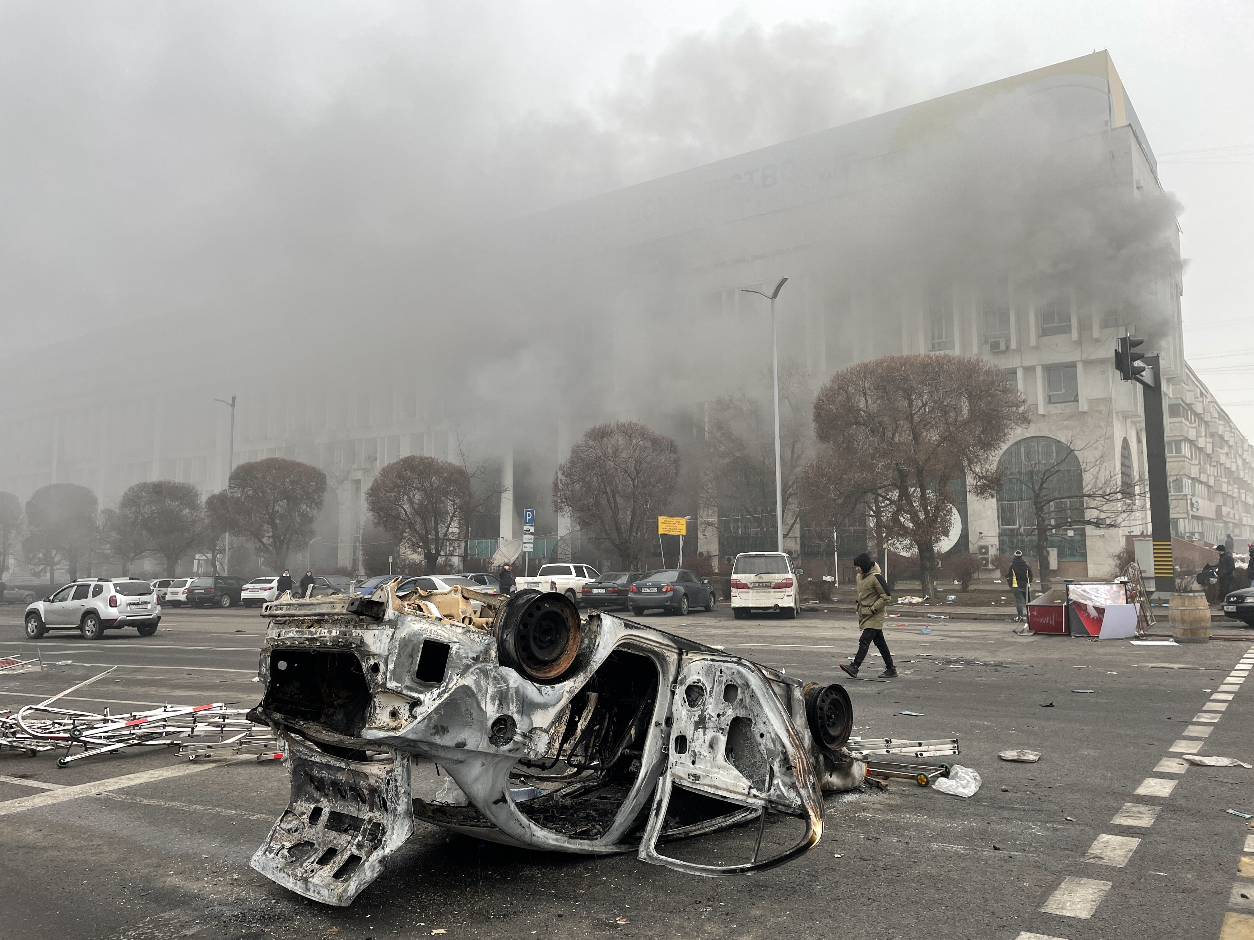 ALMATY, KAZAKHSTAN - JANUARY 6, 2022: A burnt out vehicle which was set on fire during unrest is seen in Republic Square.