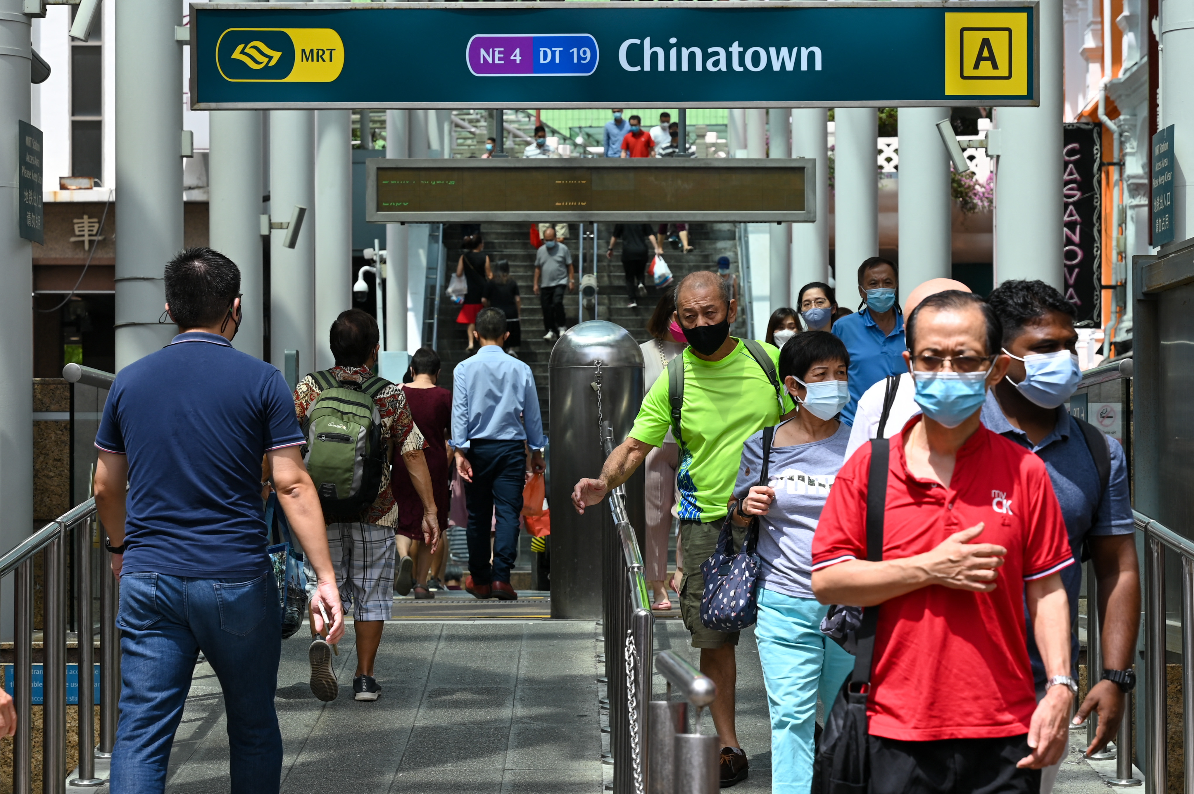 People walk in and out of the Mass Rapid Transit subway station at the Chinatown district in Singapore on Jan. 10, 2022. 