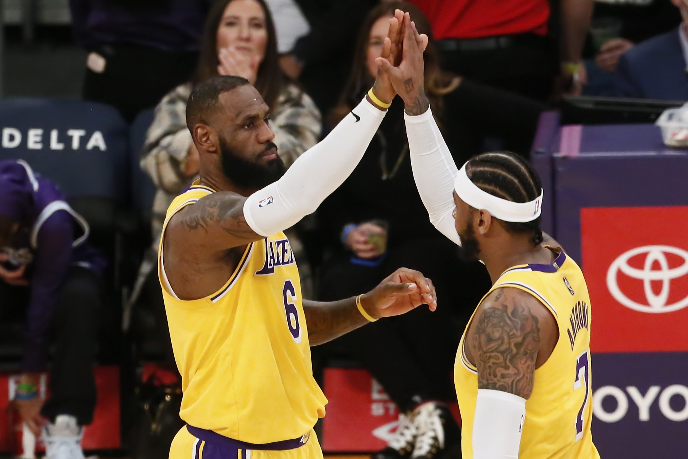 Los Angeles Lakers LeBron James and Carmelo Anthony celebrate during a game at the Crypto.com Arena.
