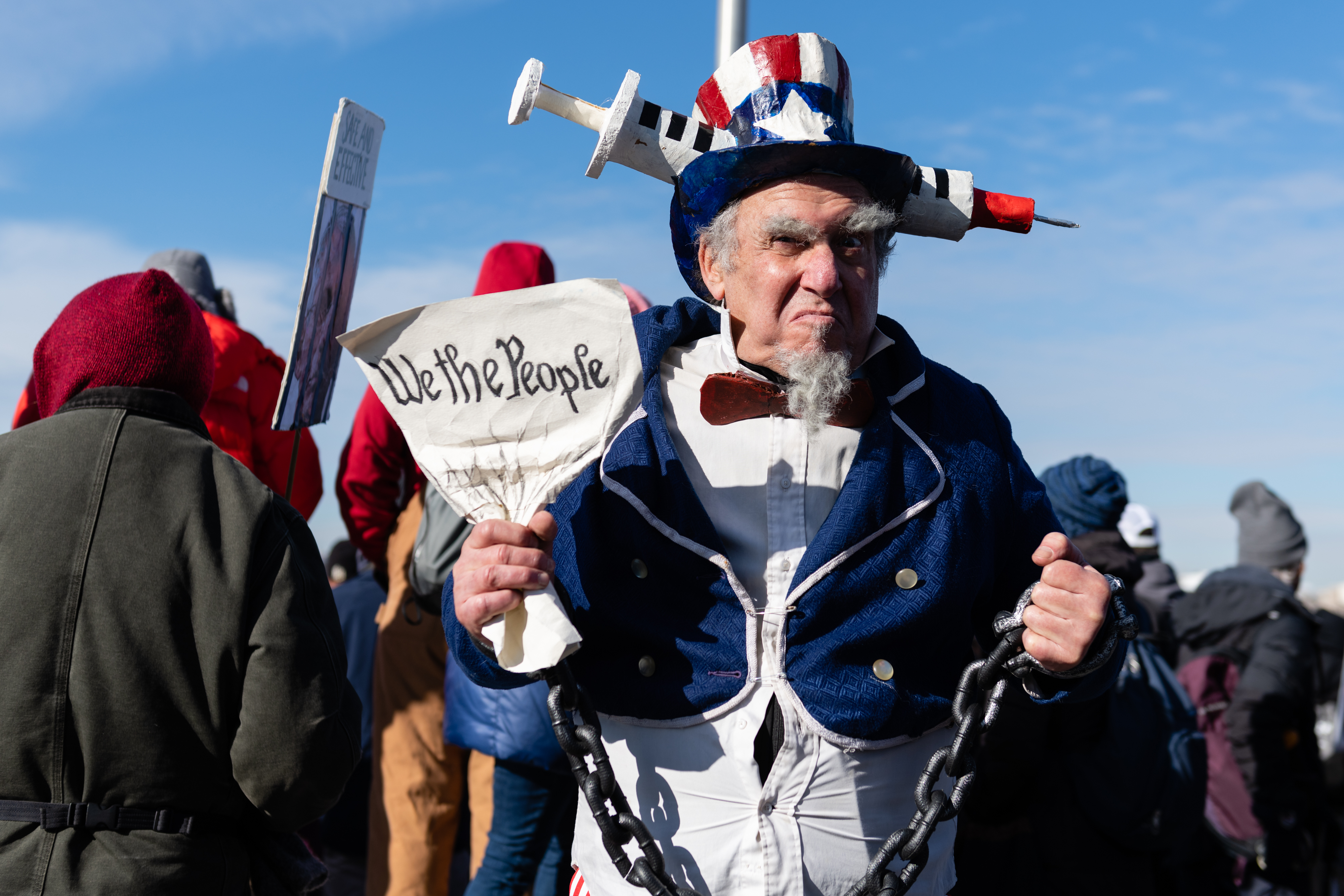 A demonstrator dressed as Uncle Sam stands for a photograph during an anti–vaccine-mandate rally at the Washington Monument in Washington, D.C., on Jan. 23, 2022. A new survey across six countries, including the U.S., show some widespread acceptance for tough new measures to fight COVID—even among a surprising number of the unvaccinated.