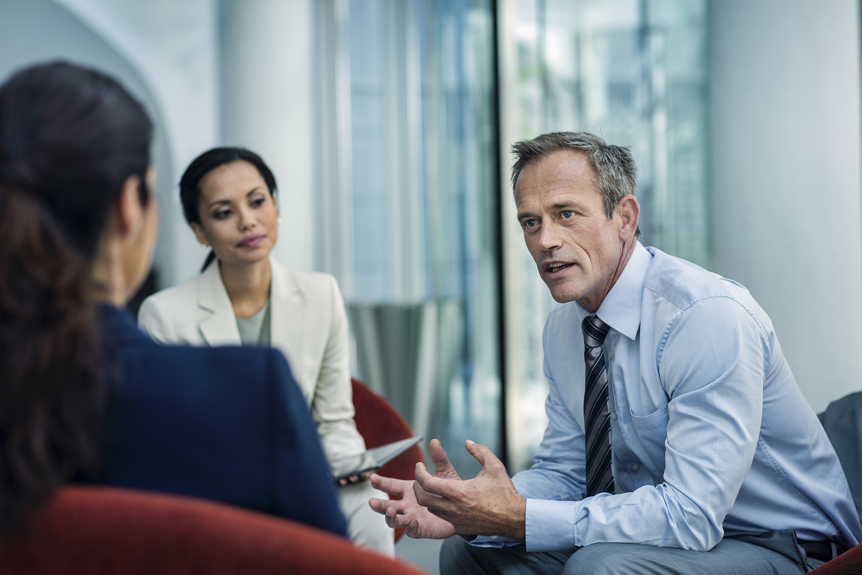 Stock photo of businessman discussing strategy with two colleagues