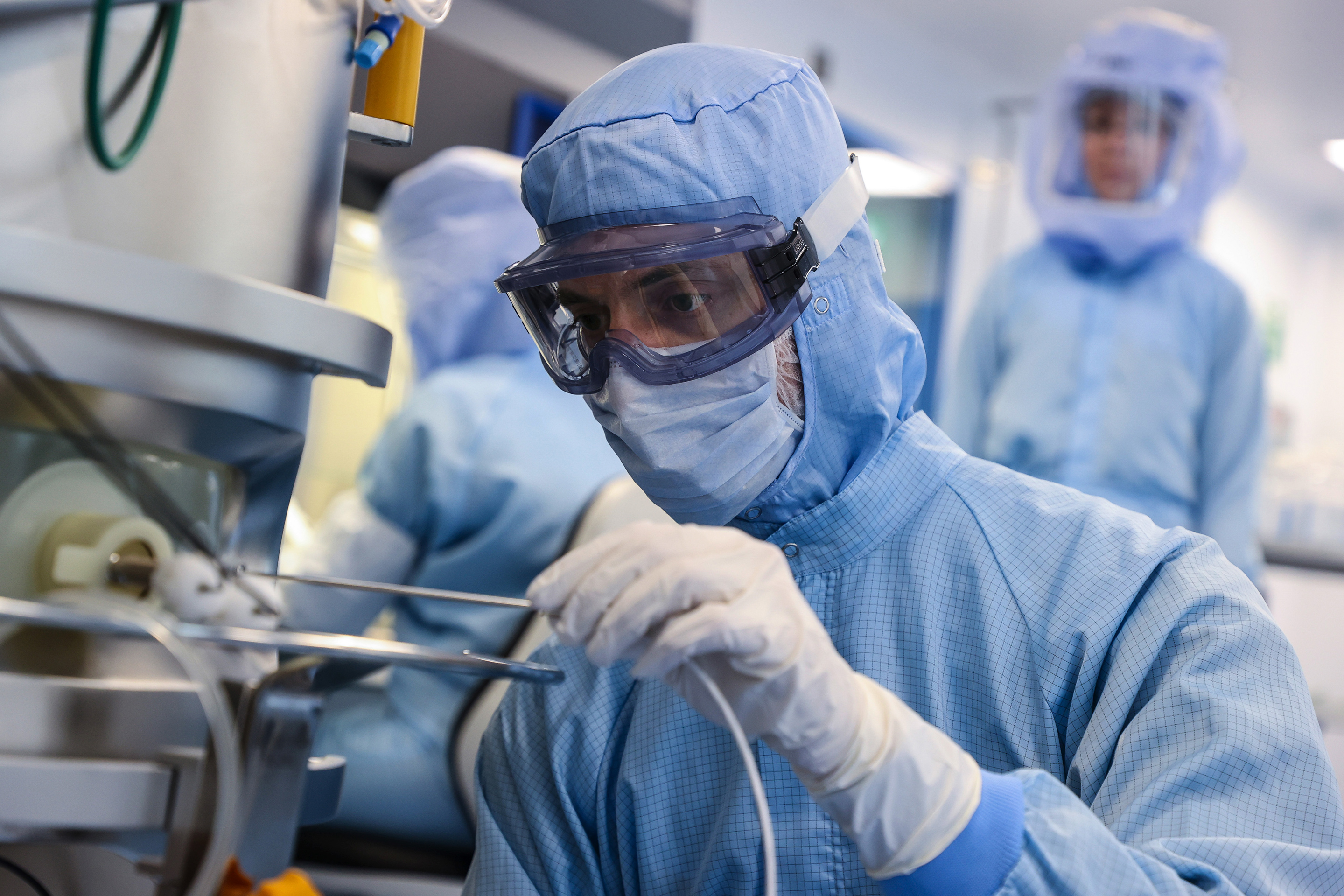 An employee readies raw materials for the Pfizer/BioNTech vaccine at a lab in Marburg, Germany.