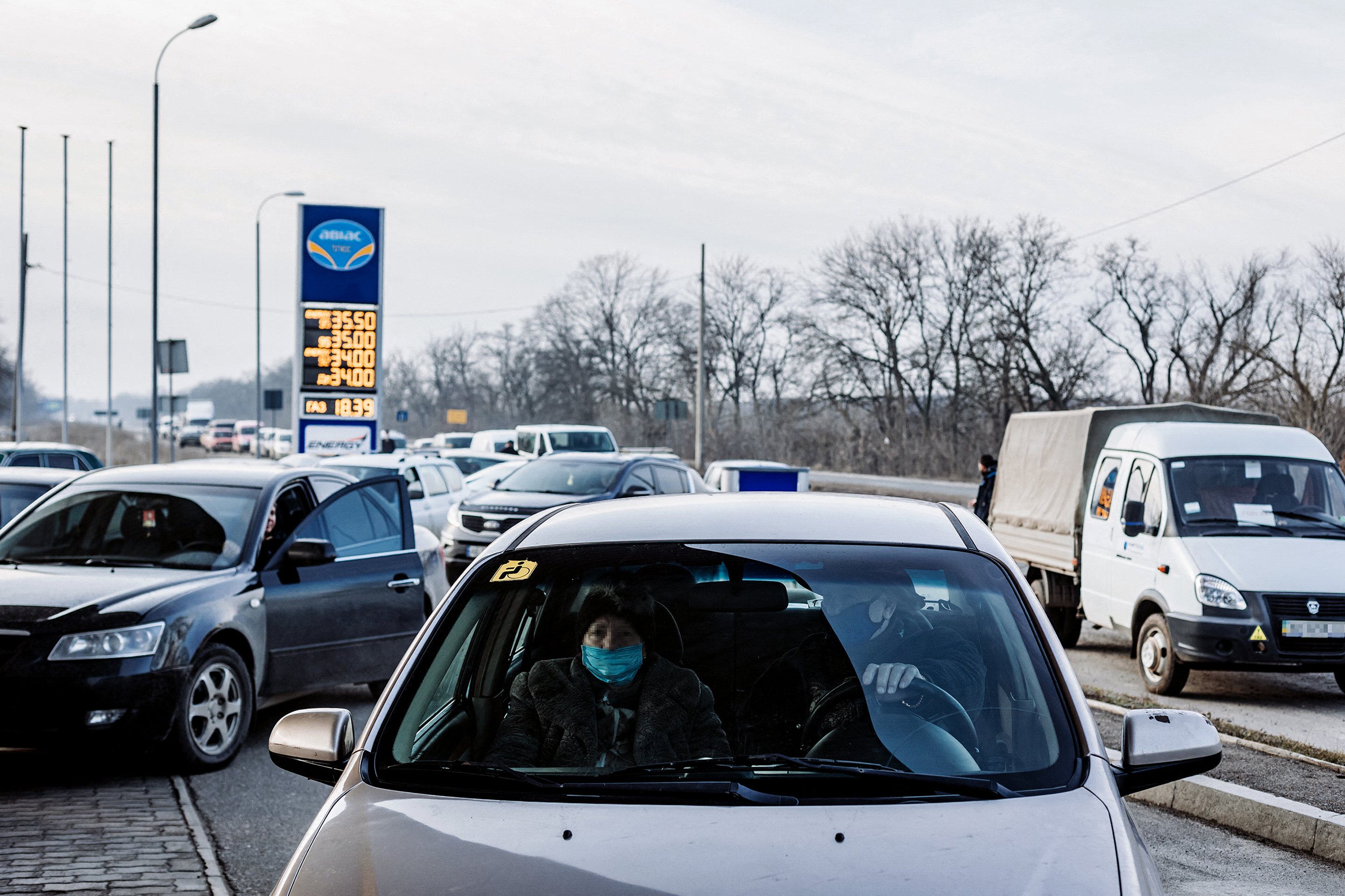 Vehicles drive to a gas station in Kramatorsk, Ukraine on February 24, 2022.