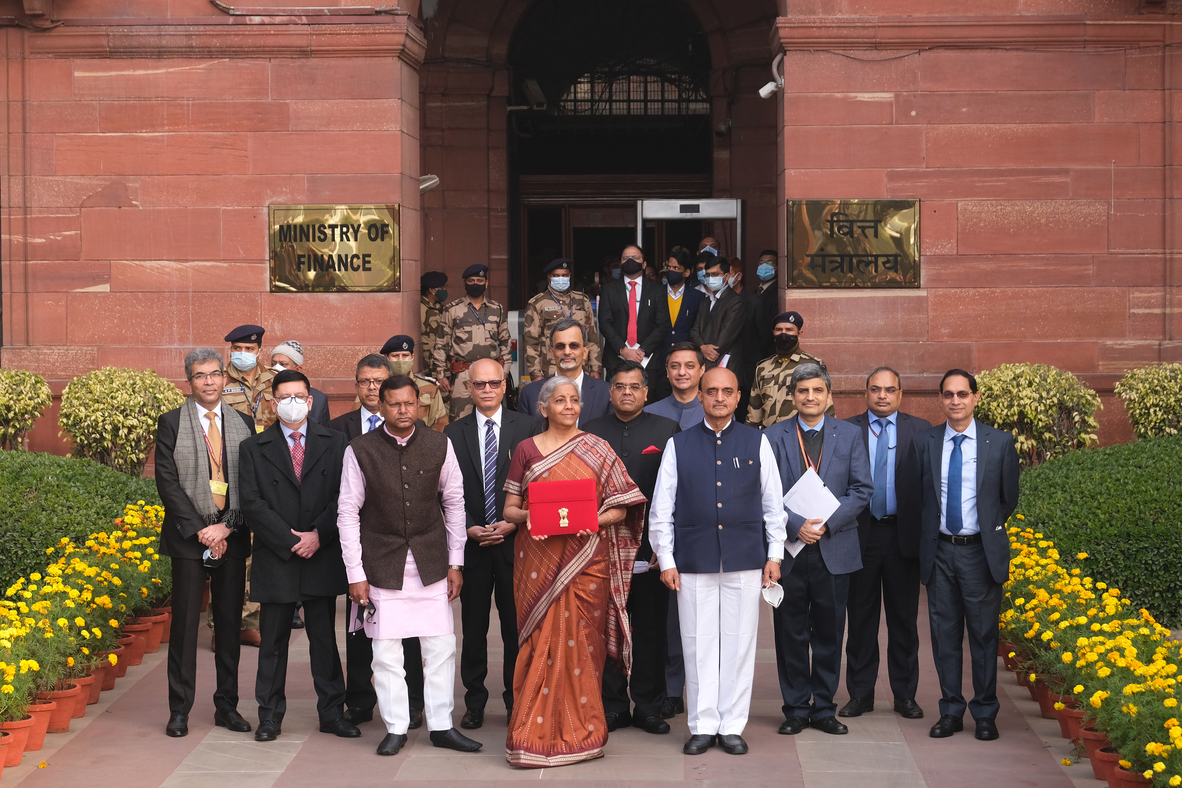Nirmala Sitharaman, India's finance minister, center, and other members of the finance ministry pose for photographs as they leave the North Block of the Central Secretariat building in New Delhi, India, on Feb. 1, 2022.