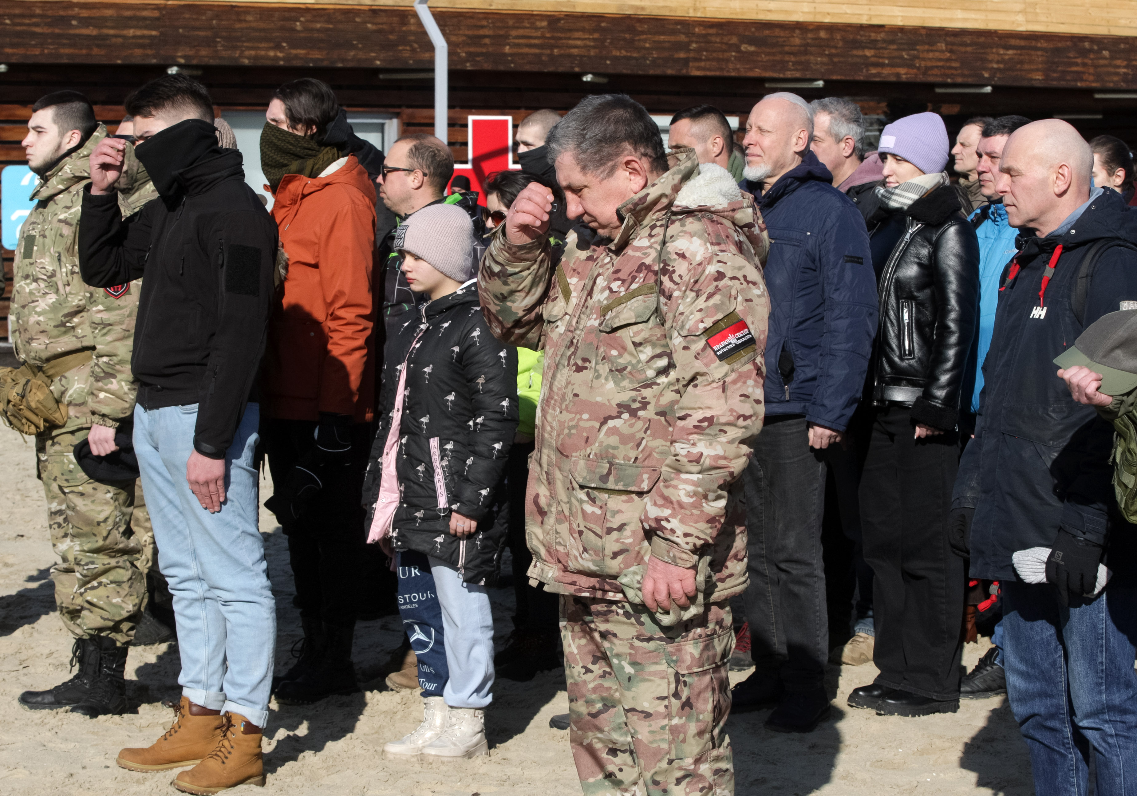 Ukrainians pray as they take part in a military training for residents, which was organized by Right Sector activists in Kyiv on Feb. 13, 2022.